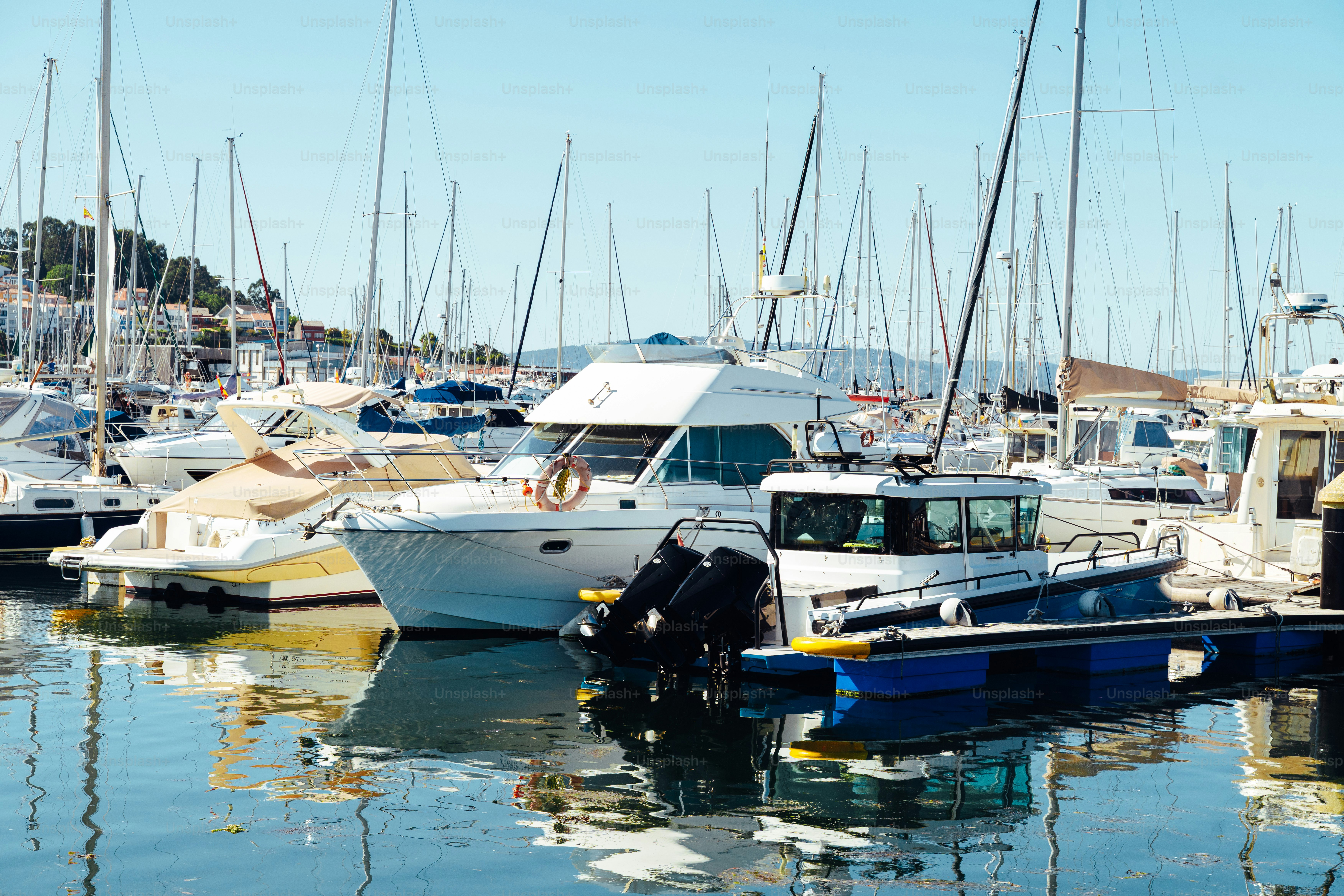 Boats are docked in a sunny harbor