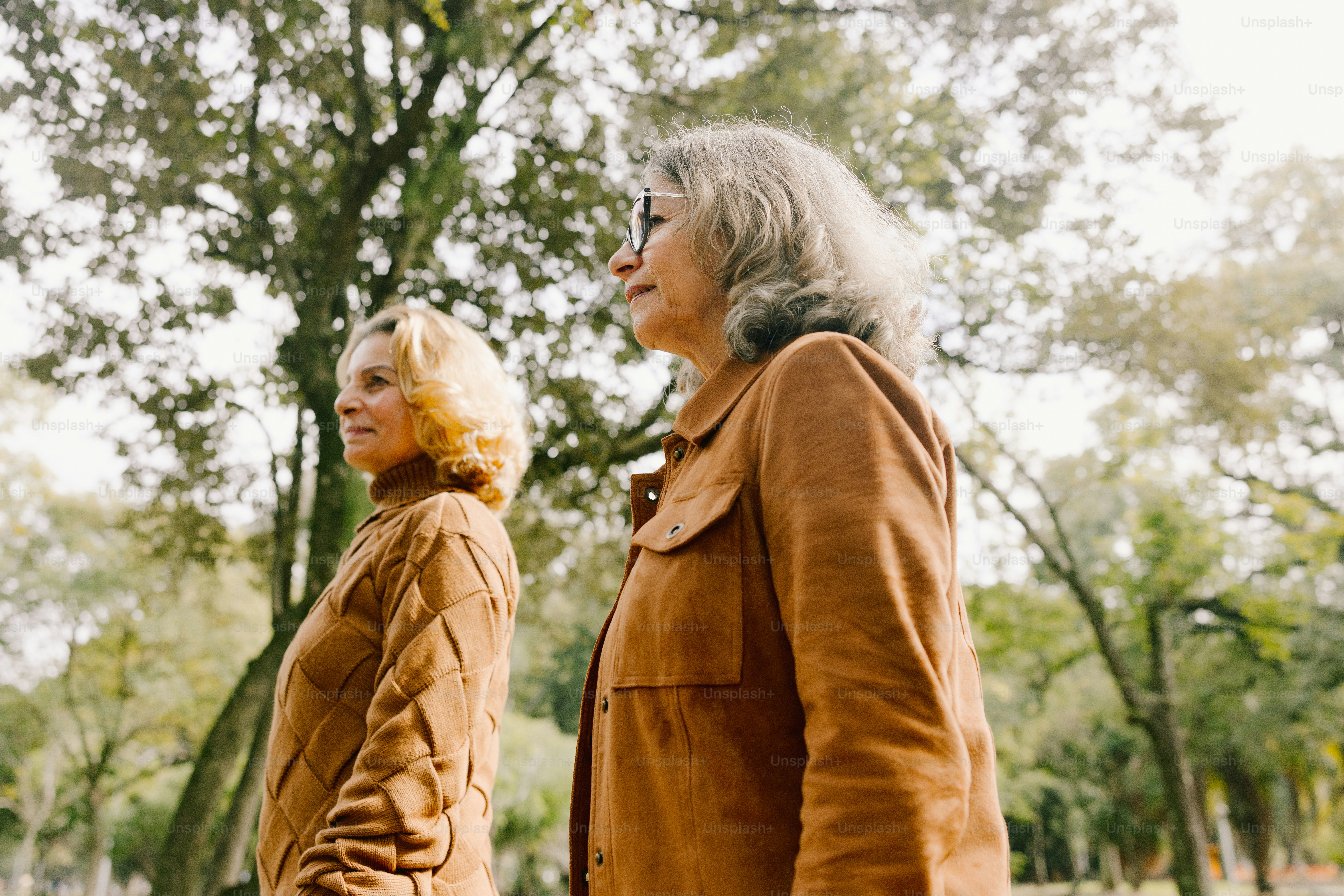 Two women are walking outside together.