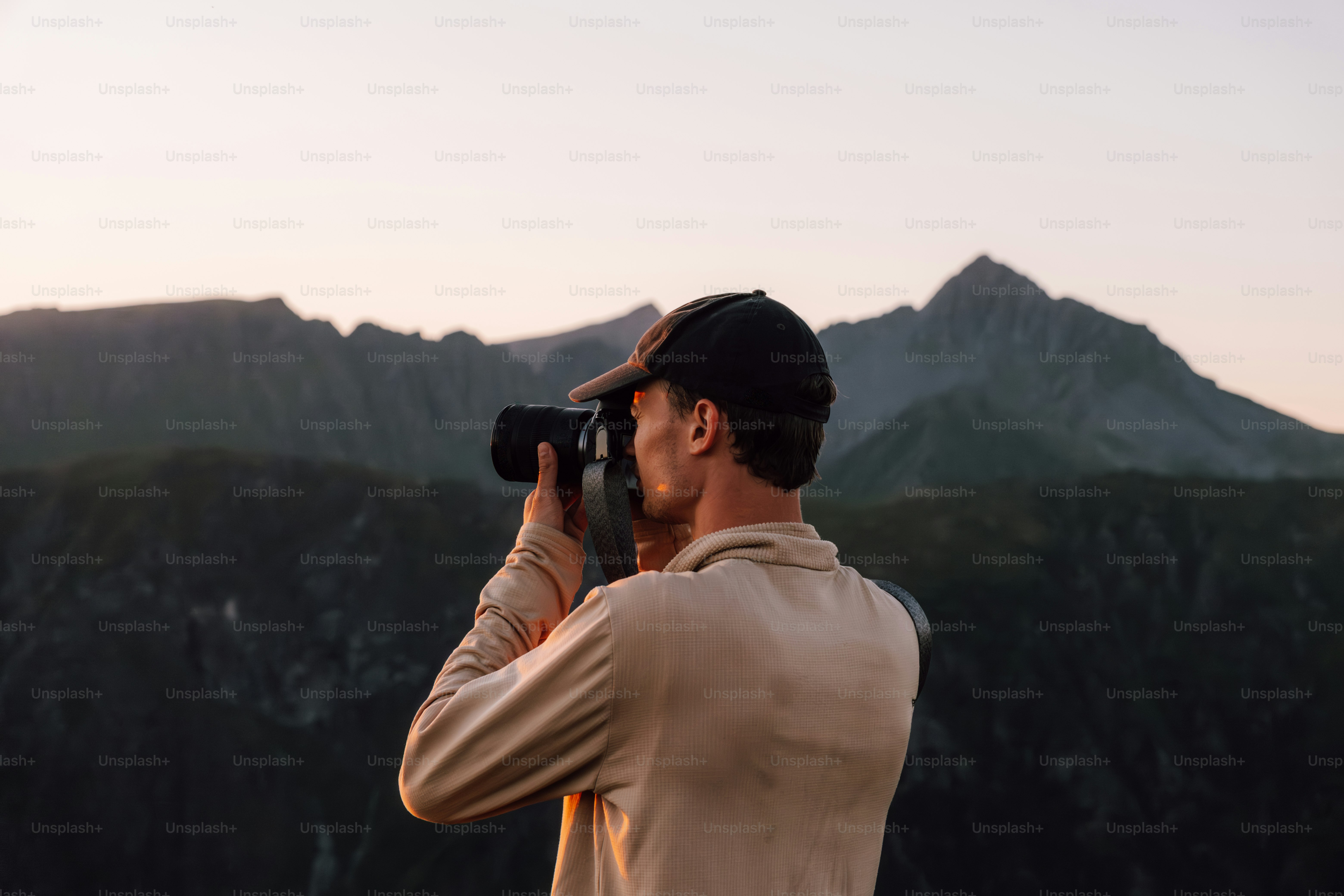 Photographer taking a picture of mountains