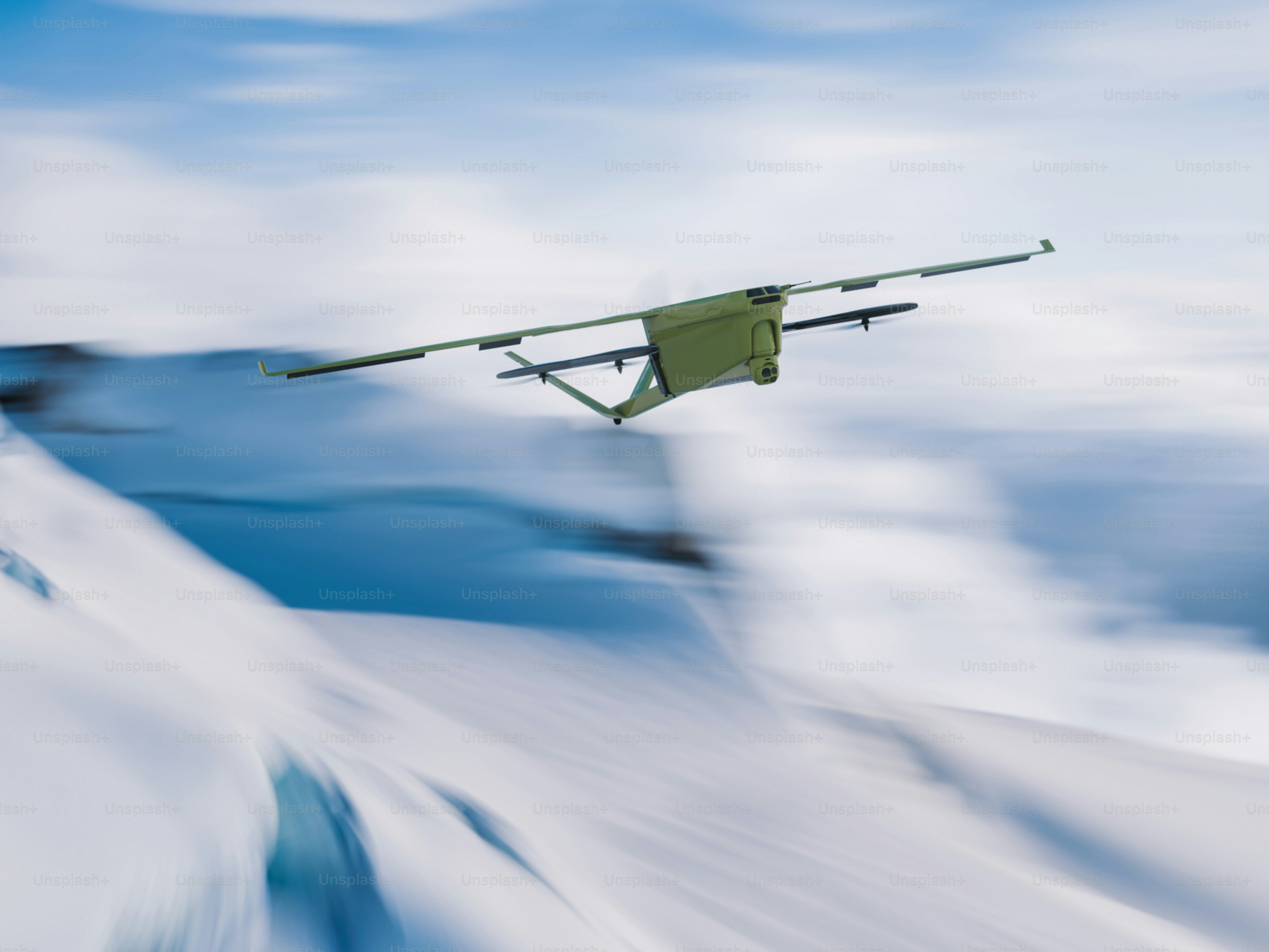 A drone flies over a snowy mountain range.