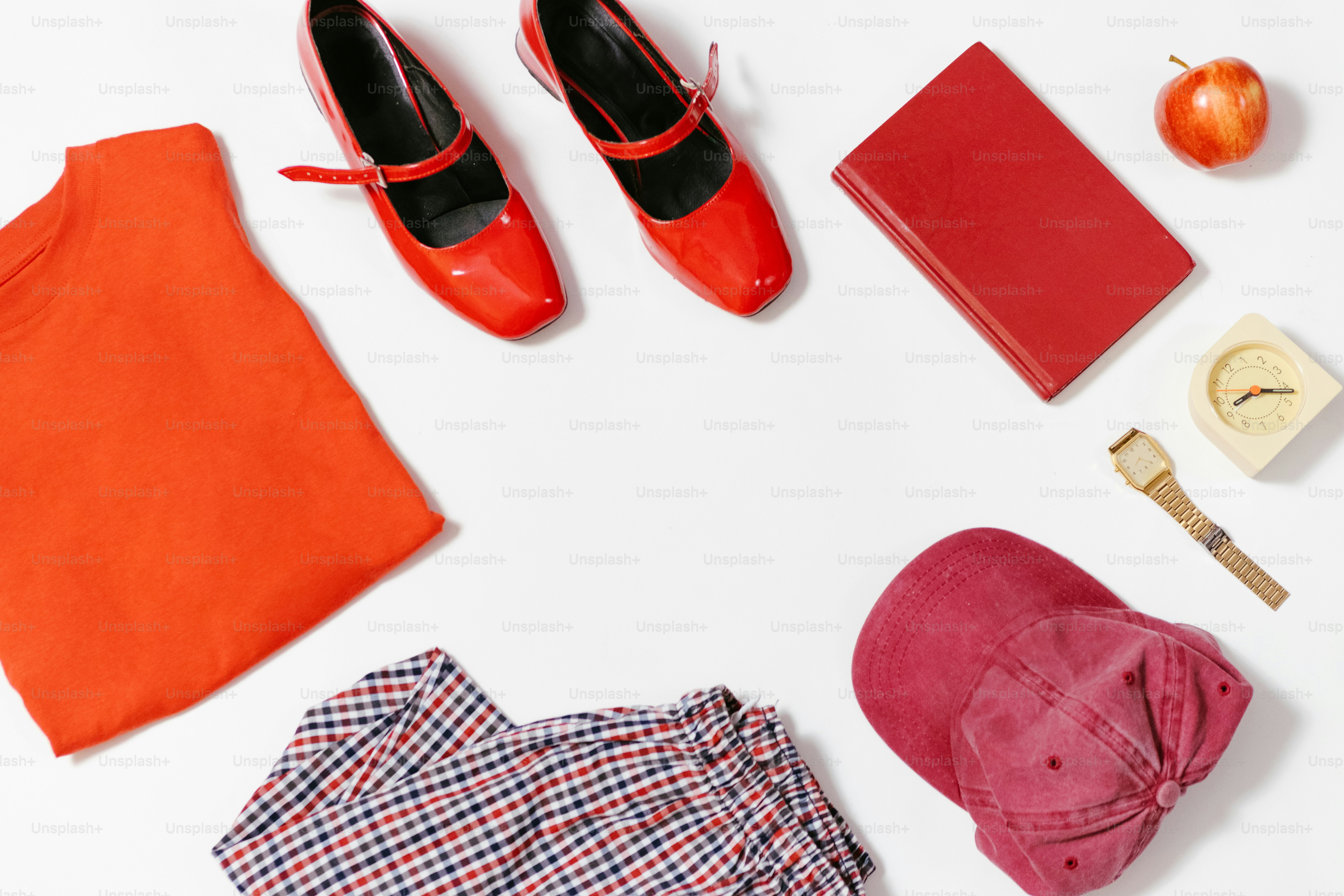 Red clothing and accessories are arranged on a white background