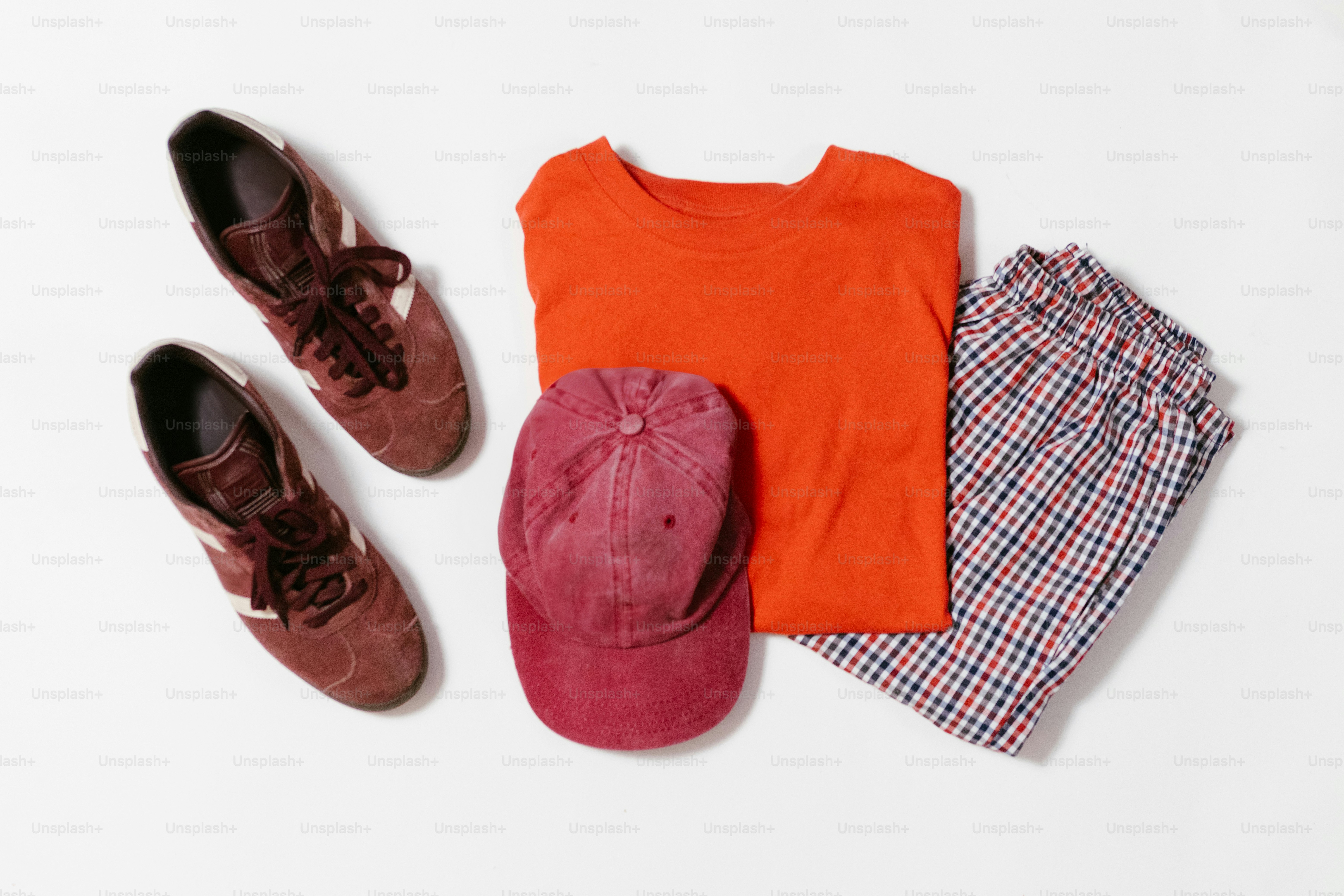 Shoes, shirt, hat, and pants are neatly arranged