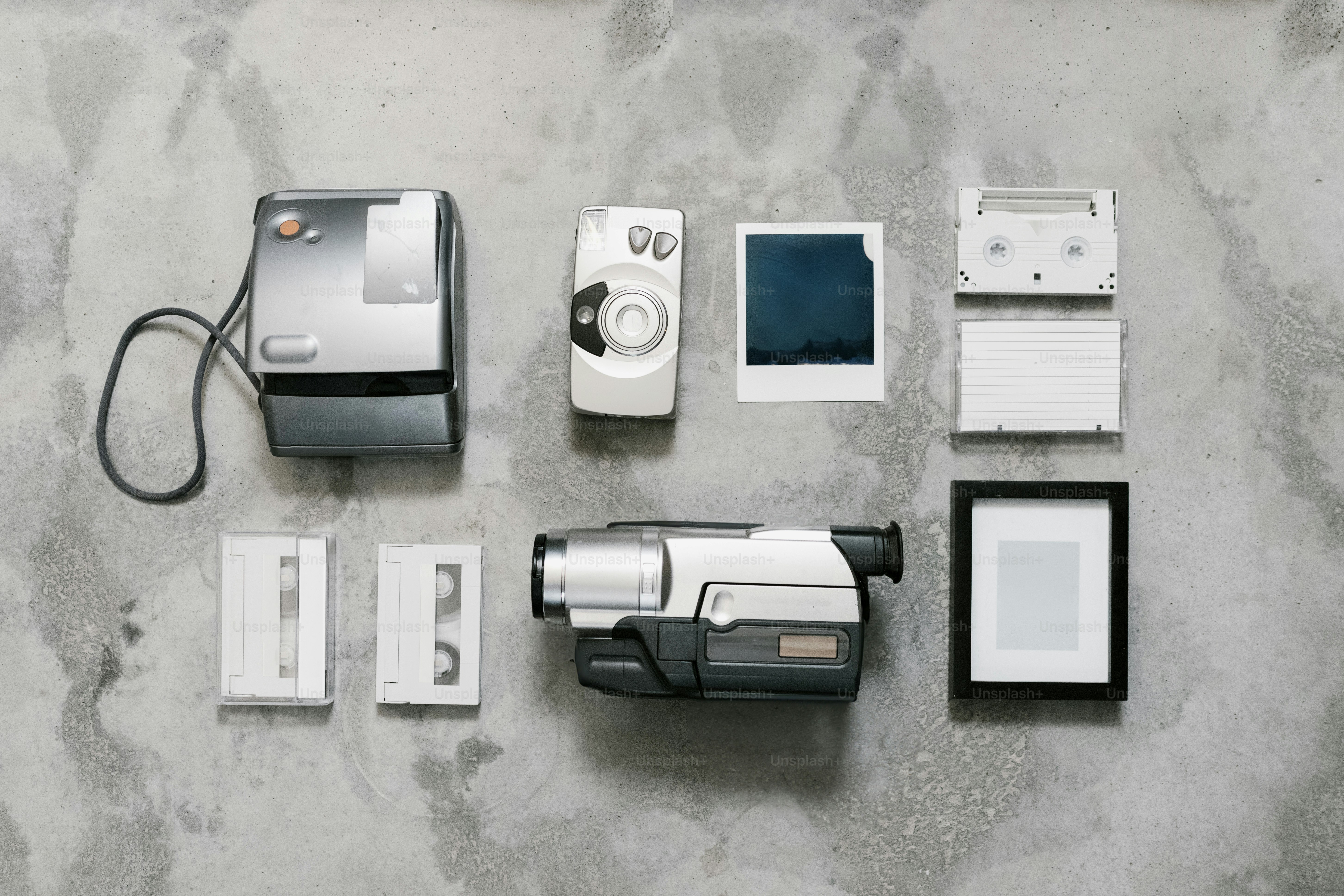 Various vintage media devices are arranged on a surface.