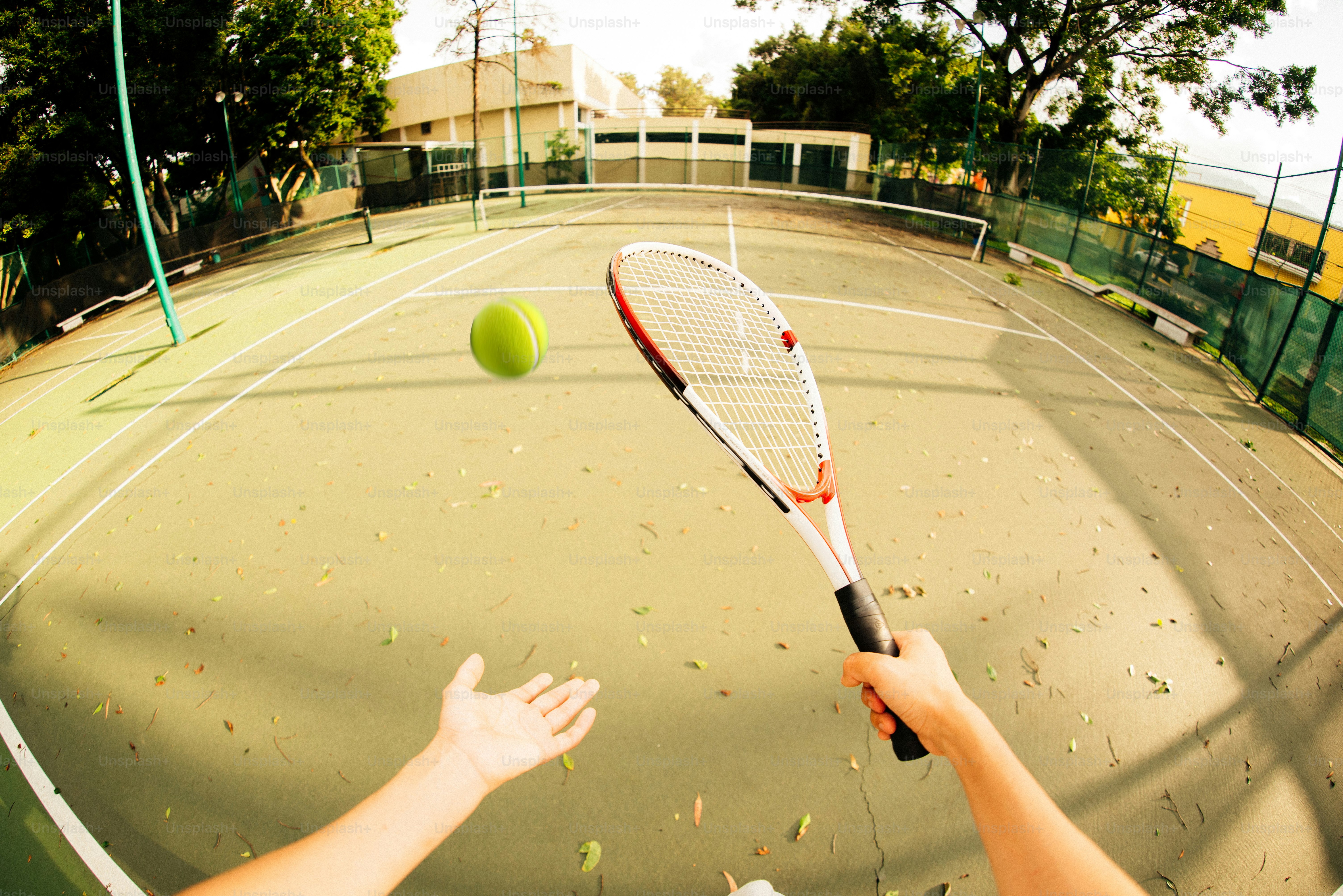 Tennis player about to hit the ball.