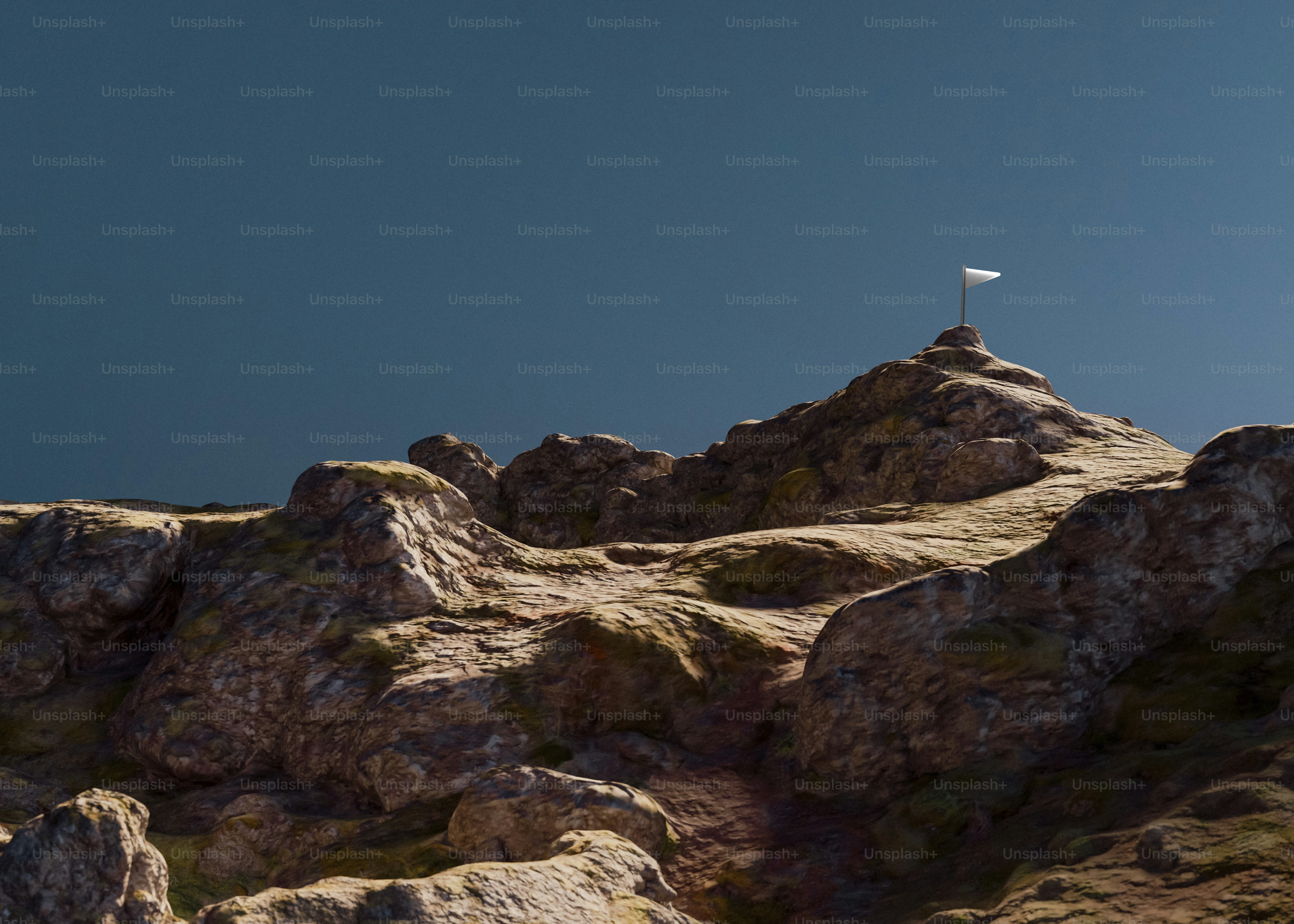 A flag flutters atop a rocky mountain.
