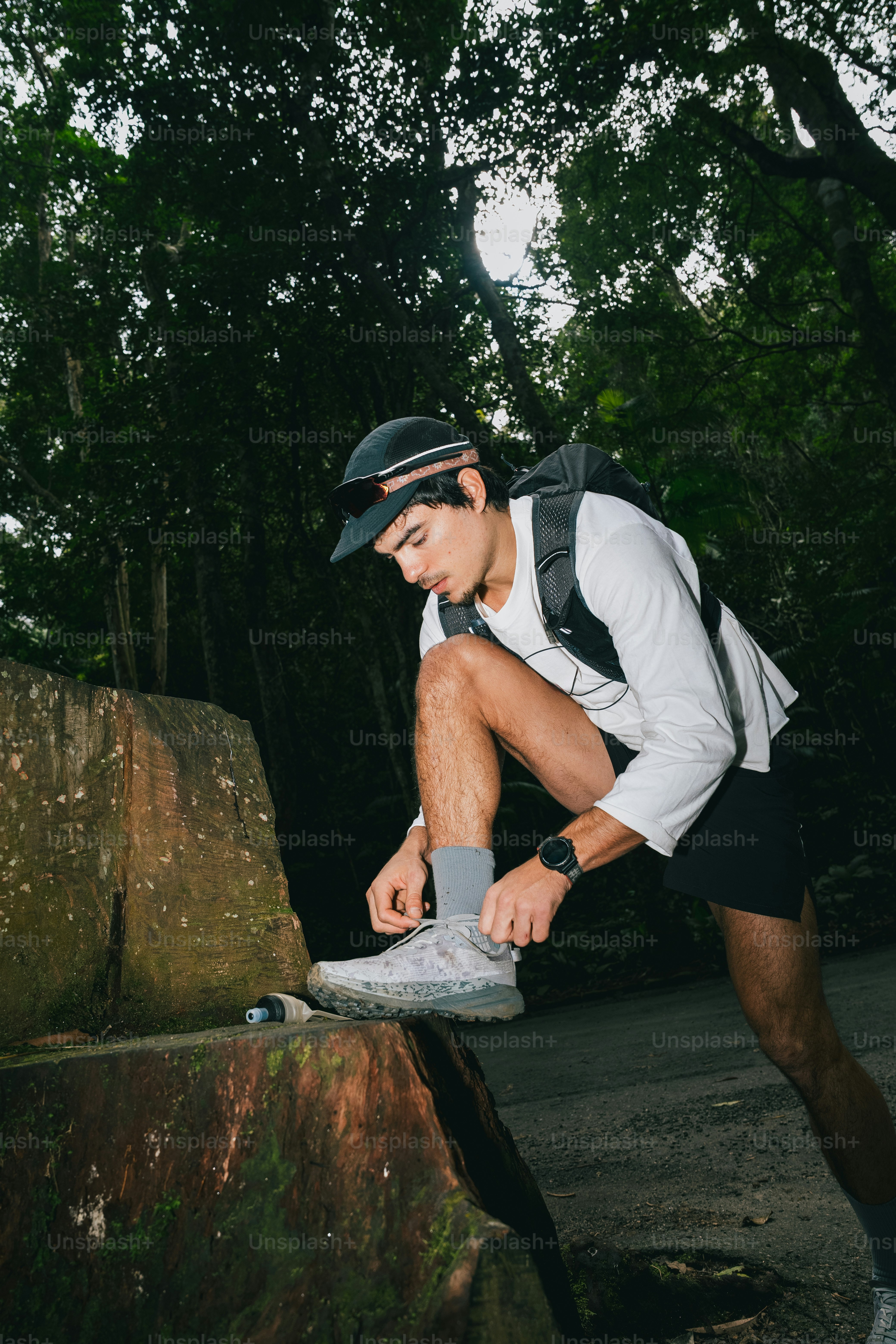A runner laces up his shoe before starting.
