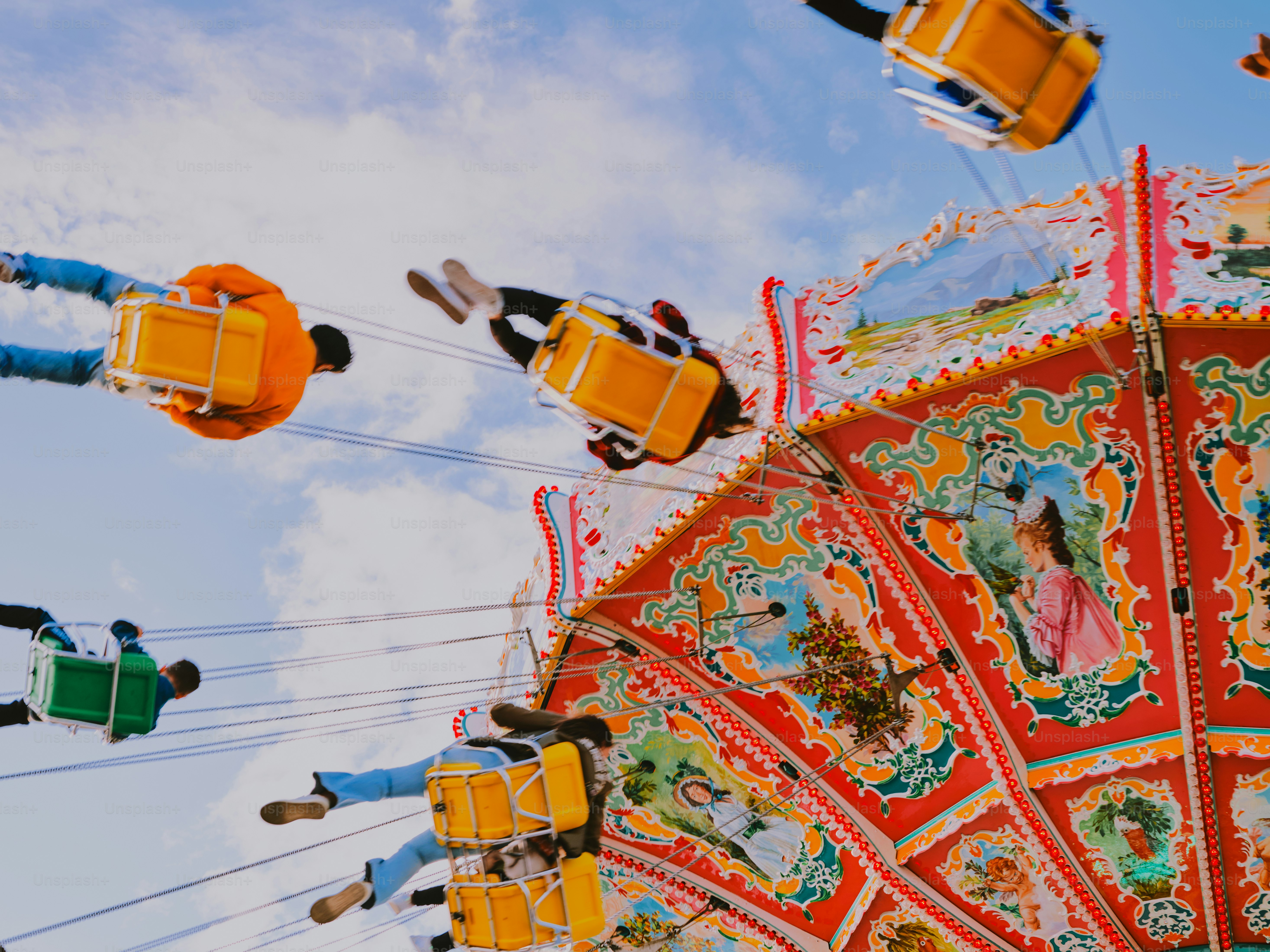 People enjoy a swing ride at a carnival.