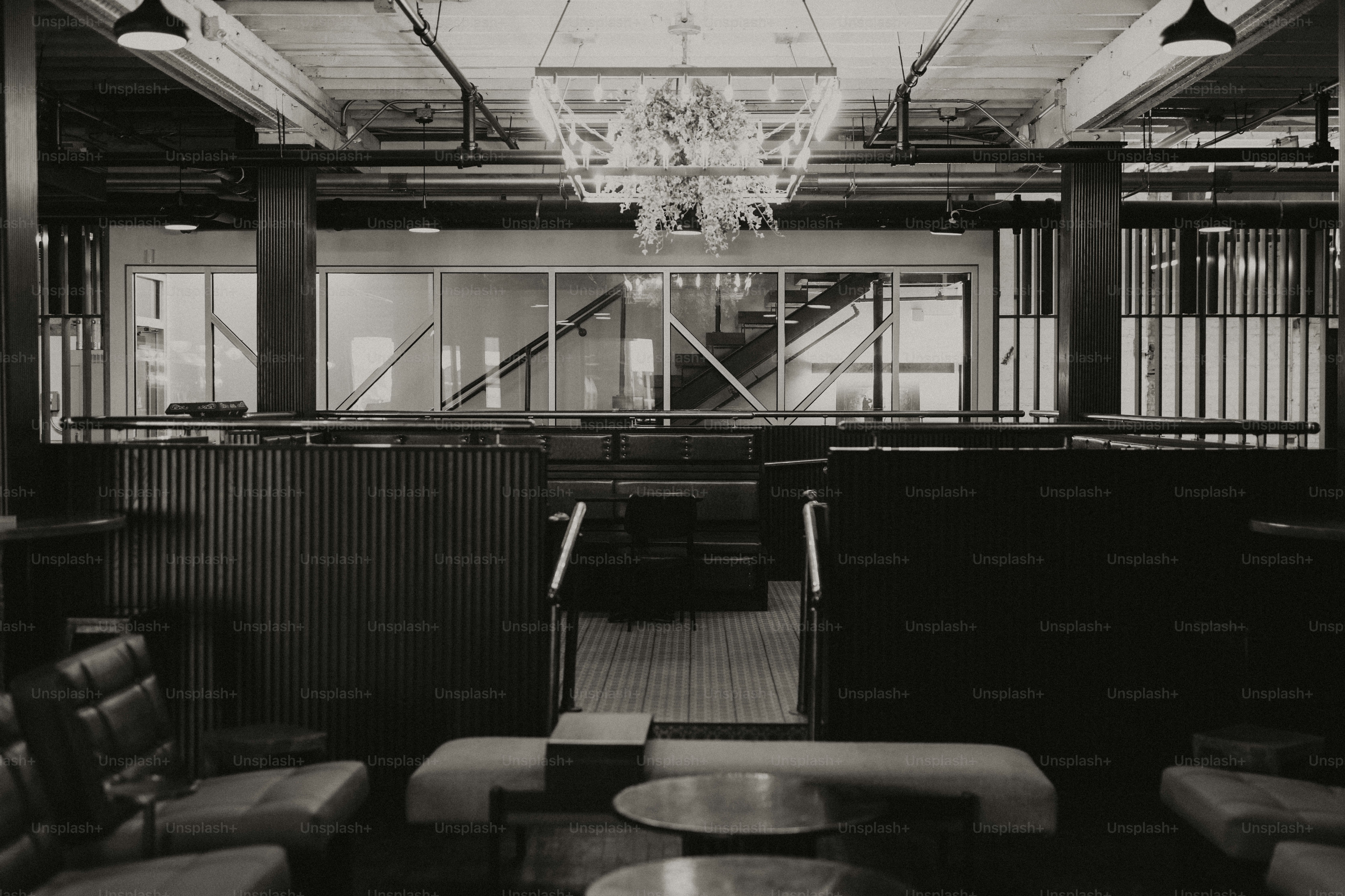 Modern interior with unique seating and chandeliers.