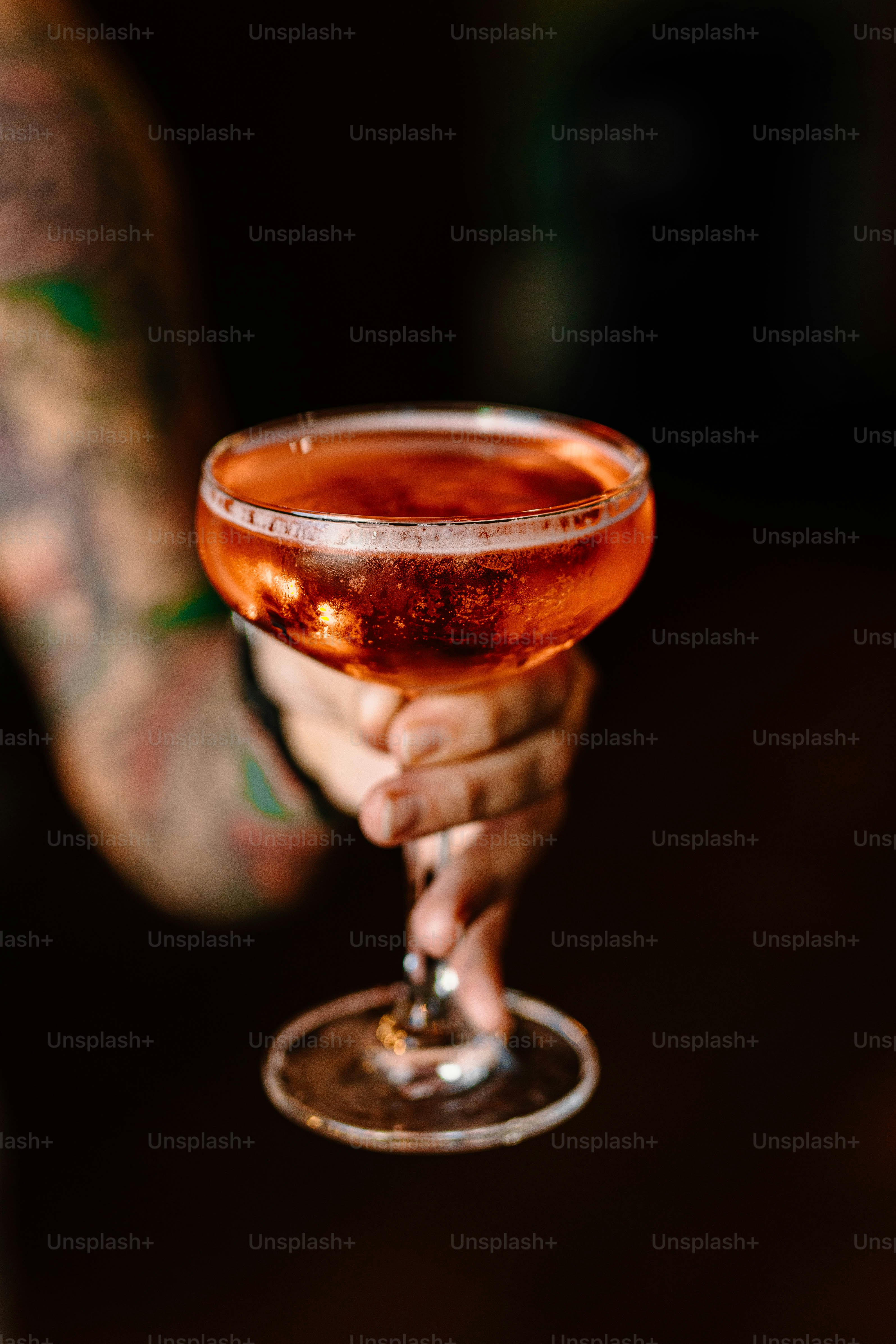 A person holds a cocktail.