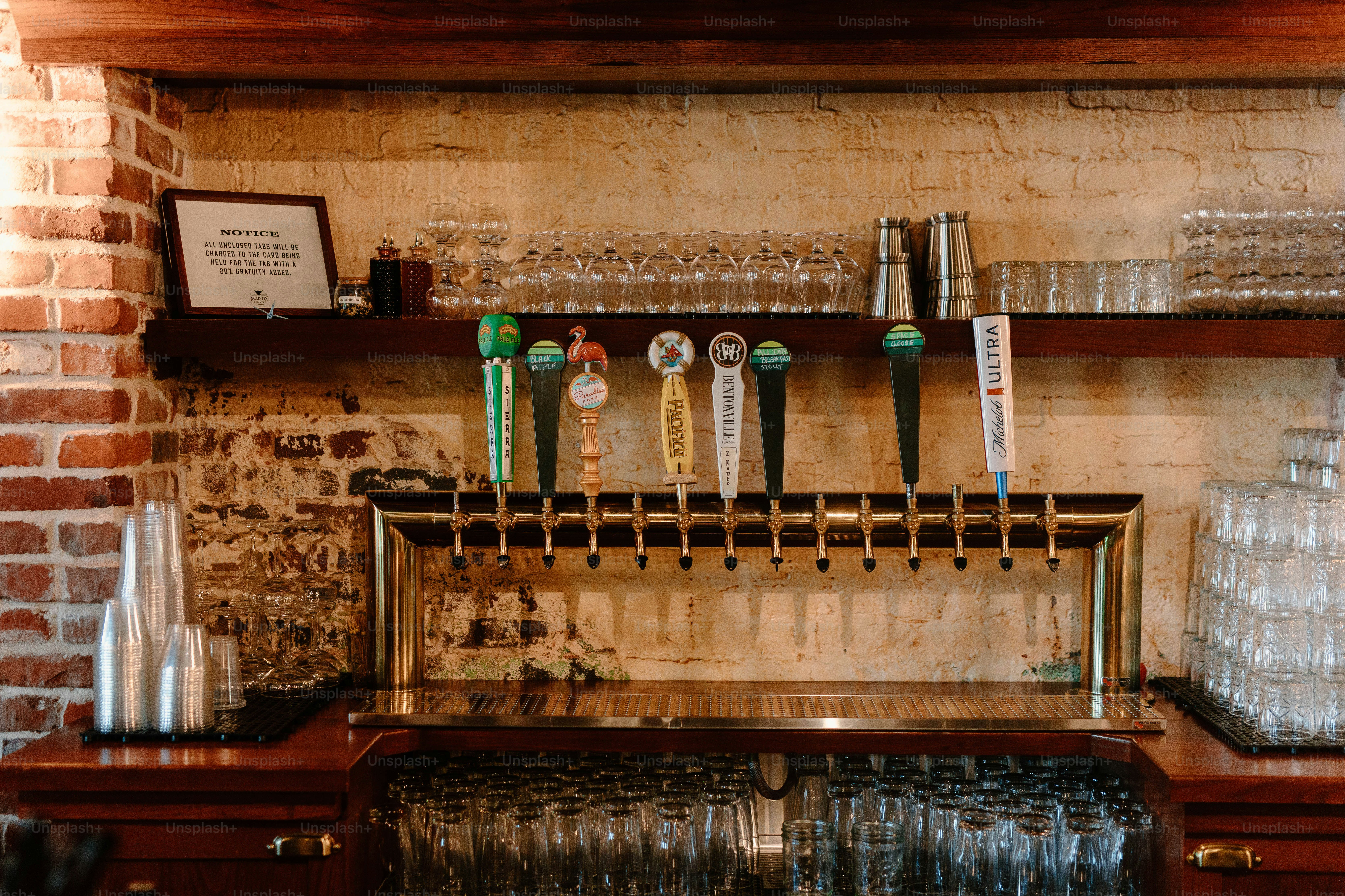 A bar with taps and a variety of glasses