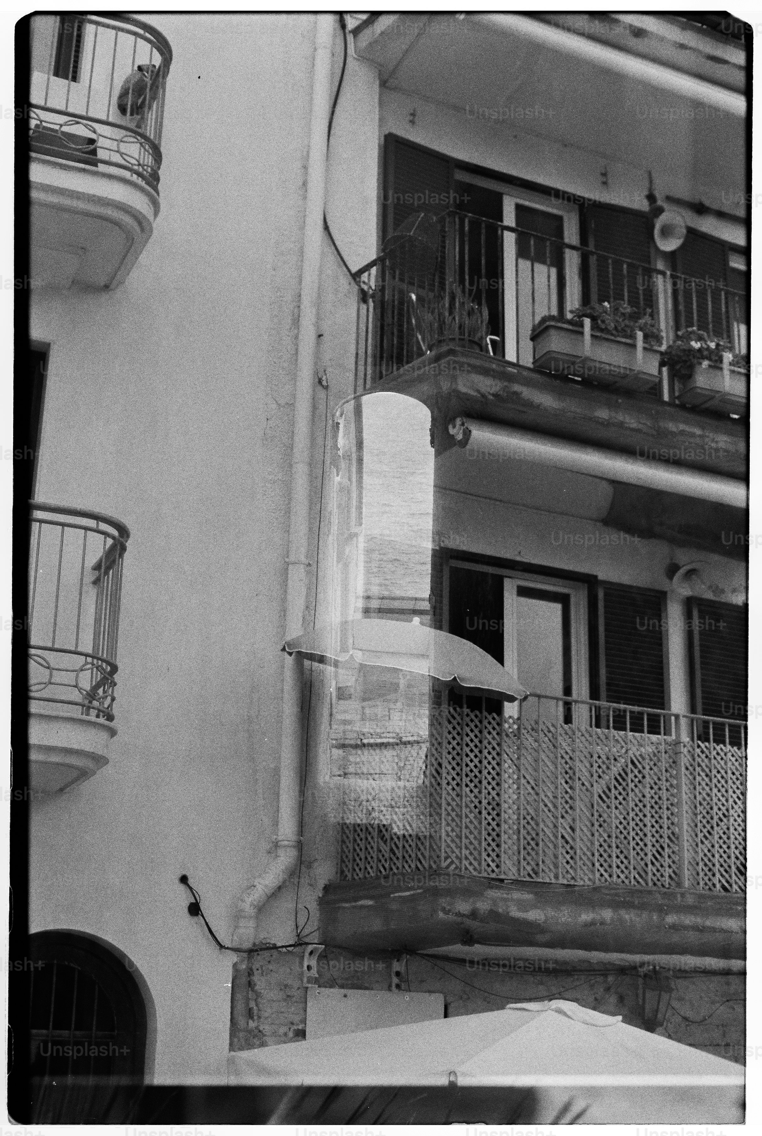 Buildings with balconies and a partially-visible ocean.