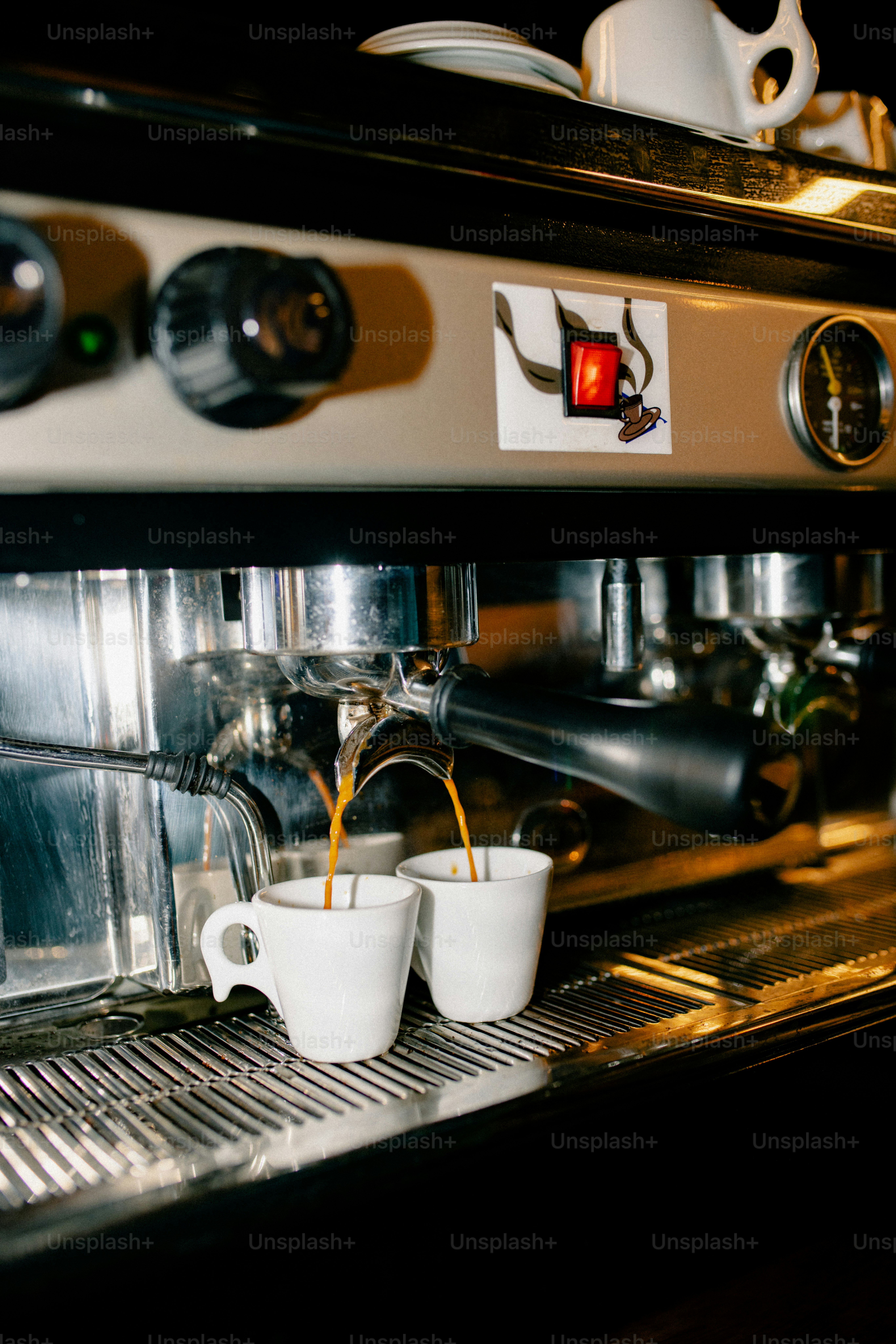 Espresso machine brewing coffee into two cups.