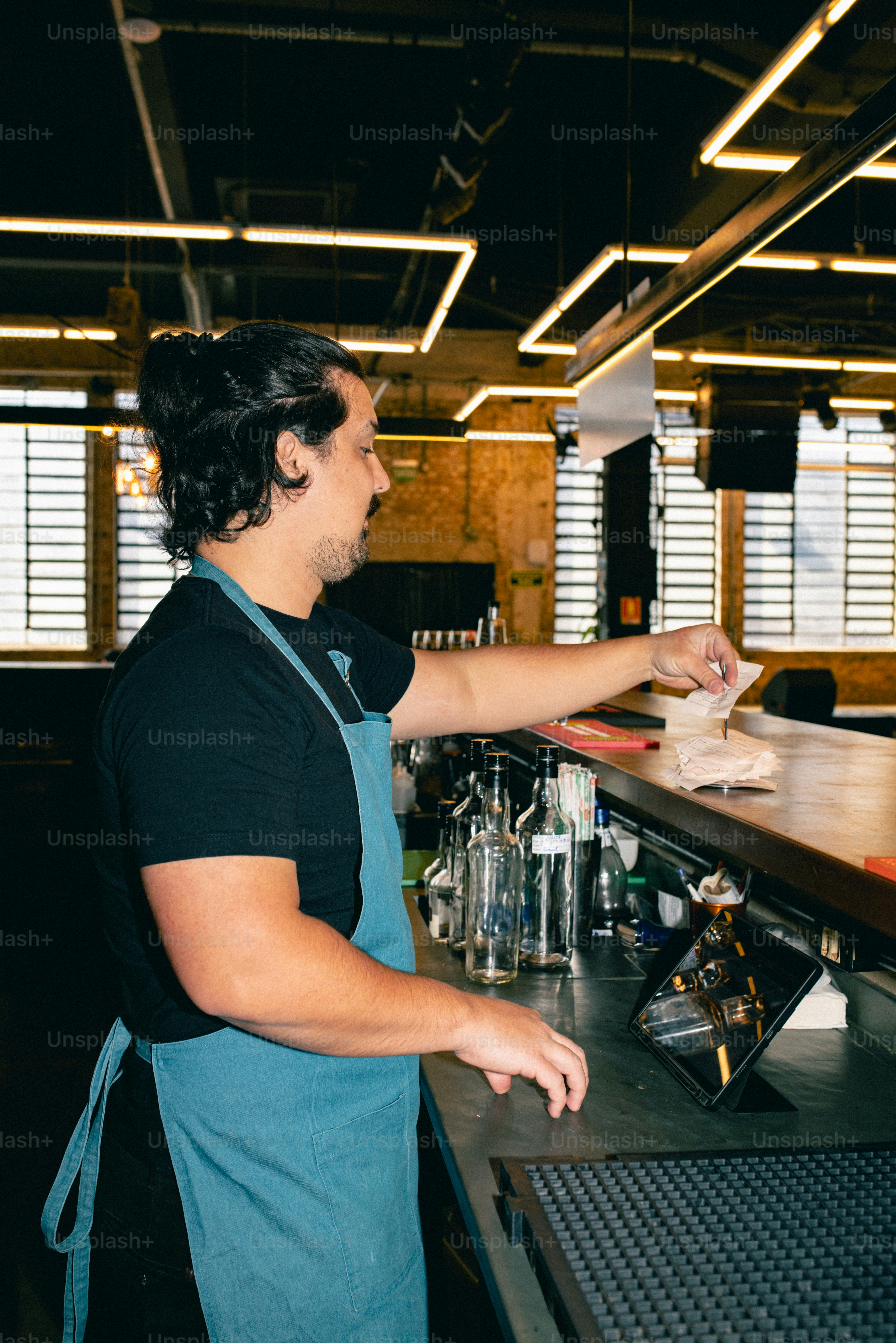 A bartender is working behind the bar.
