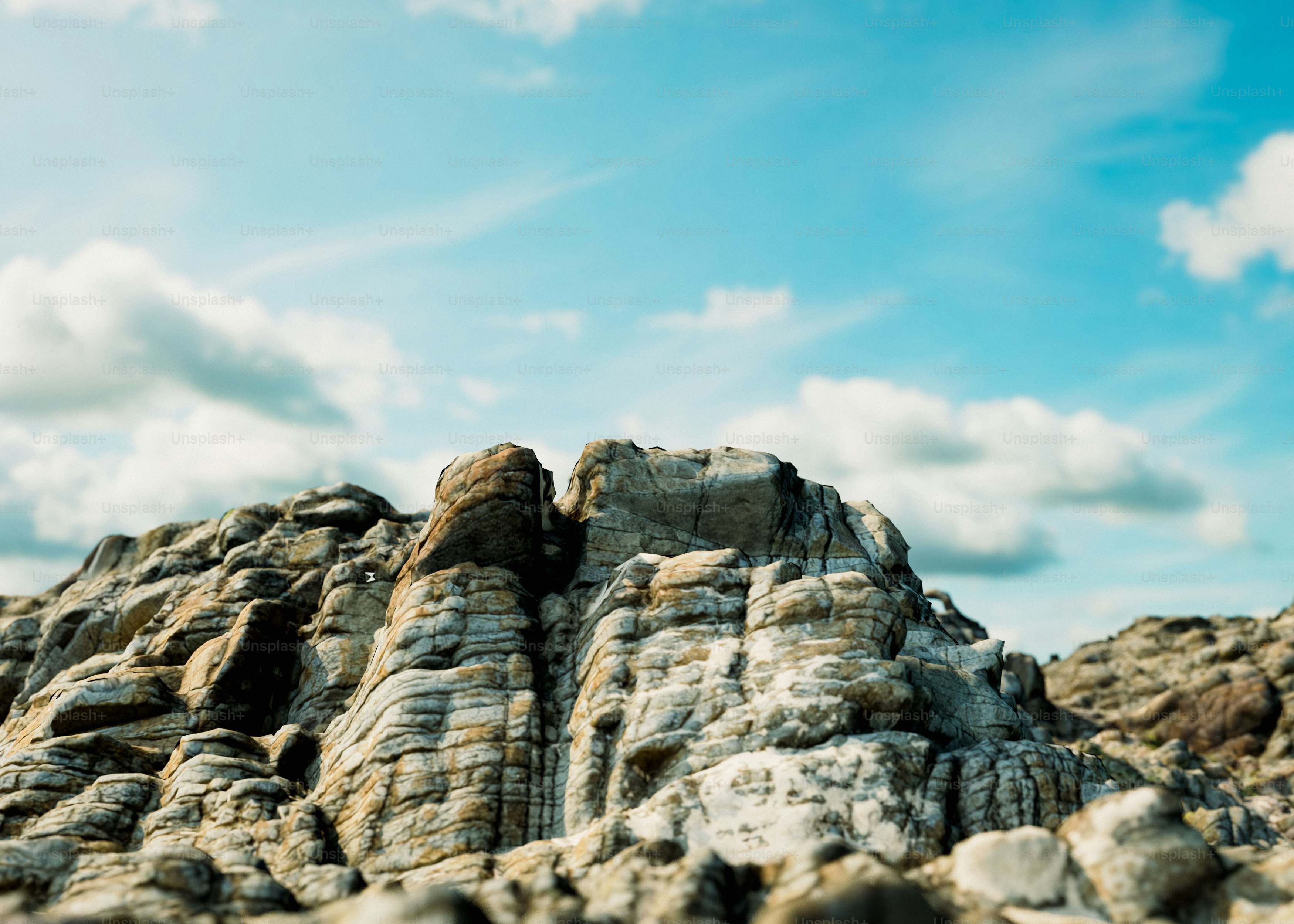 Rocks sit under a beautiful, cloudy sky. photo – Render Image on Unsplash