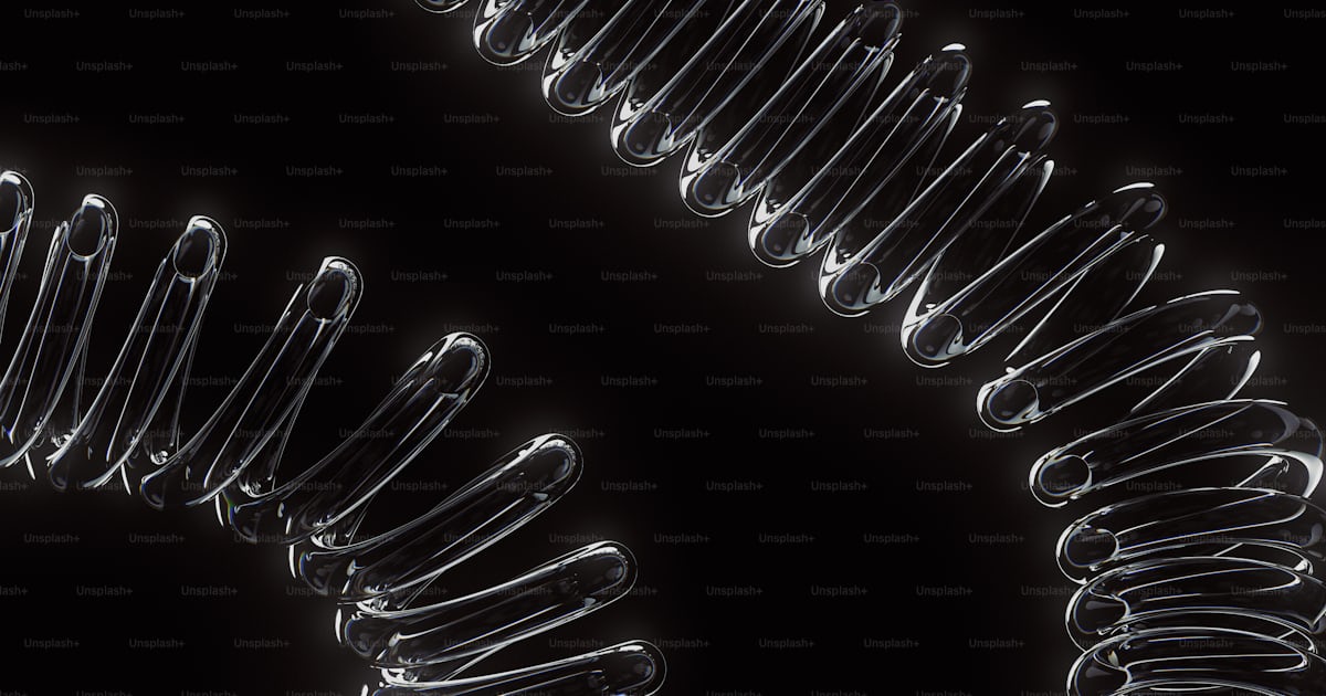 Clear, coiled springs arranged against a black background. photo ...