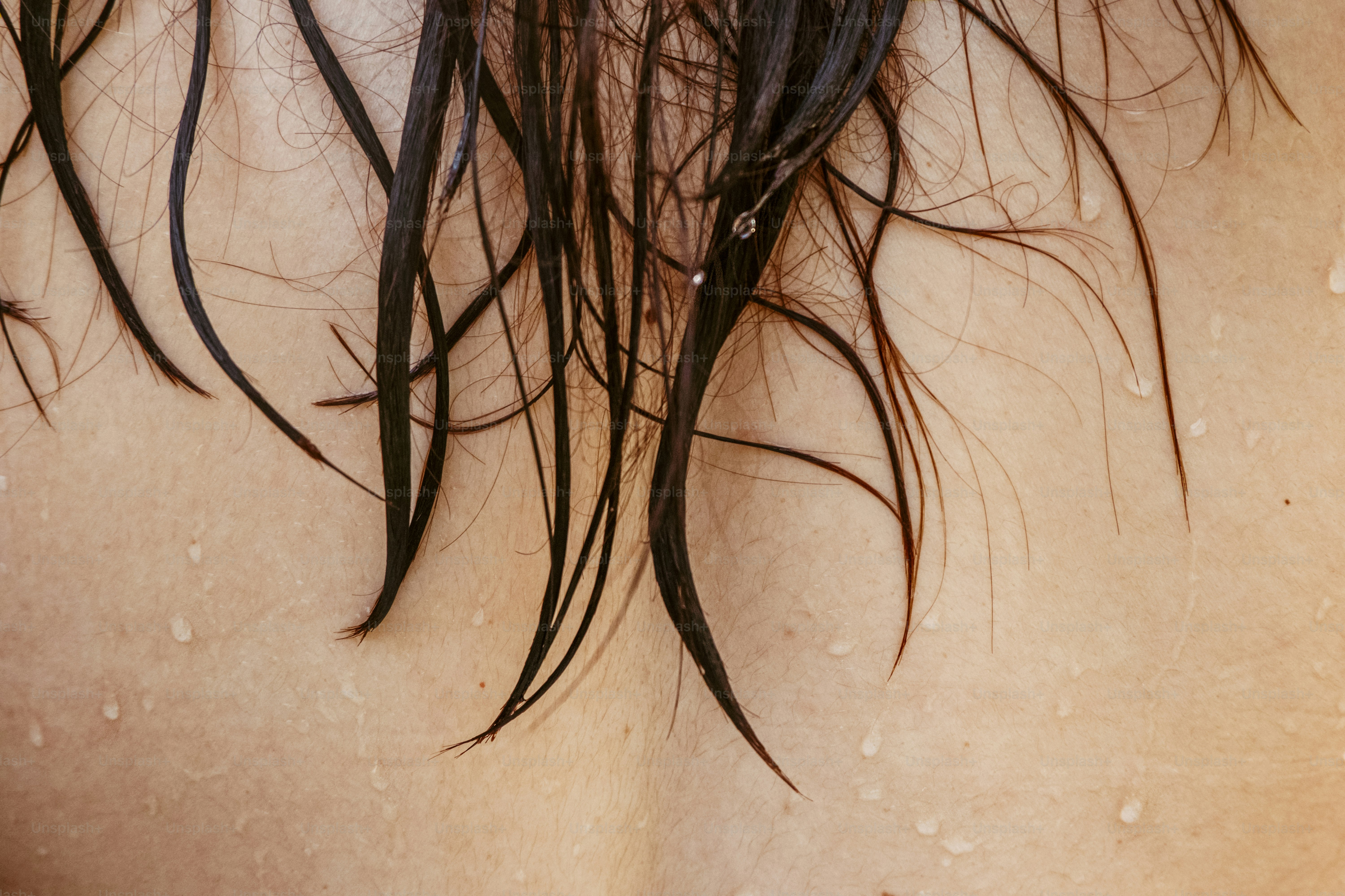 Wet hair drapes across a person's back.