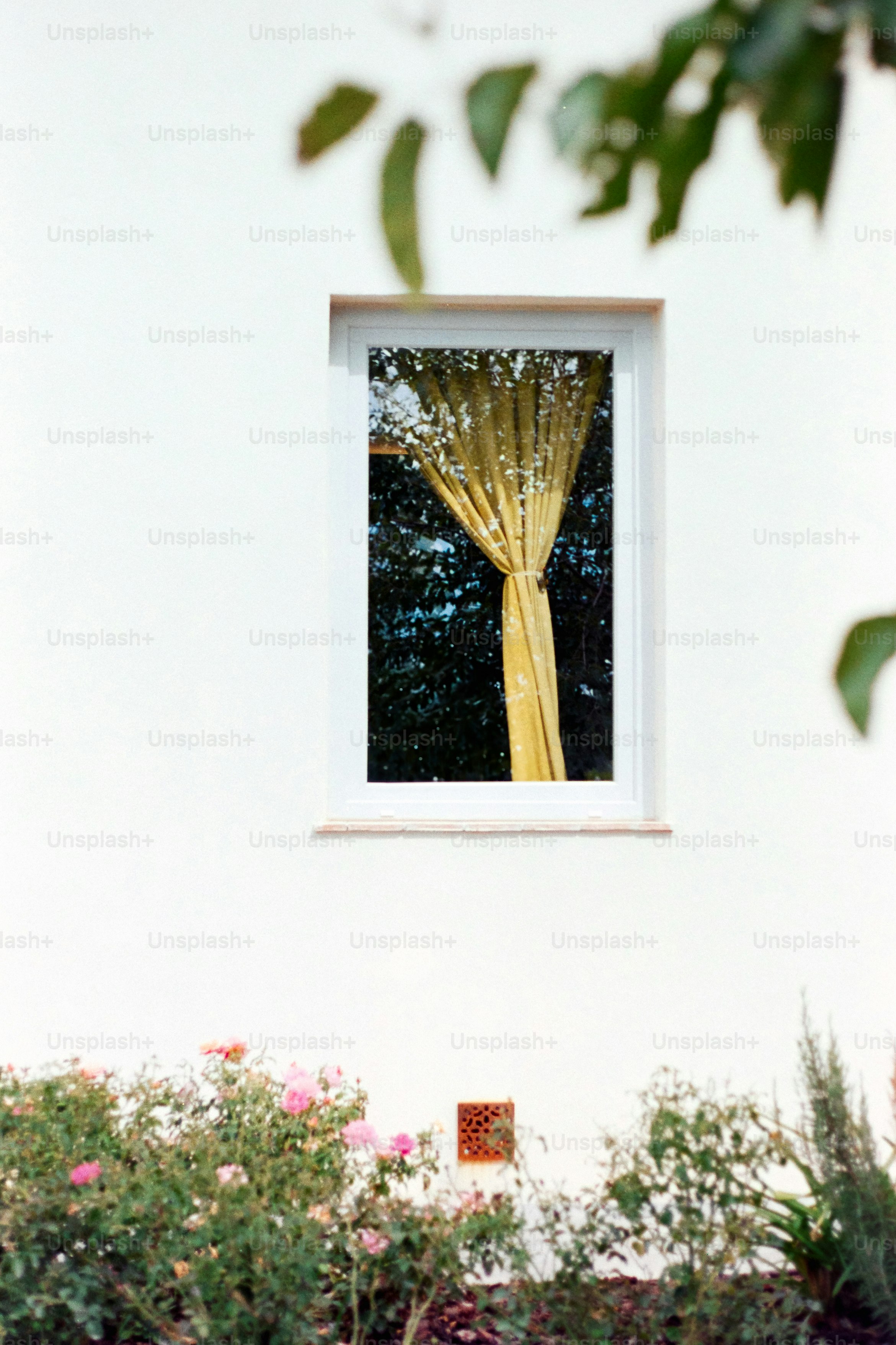 A window shows a yellow curtain and outdoors.