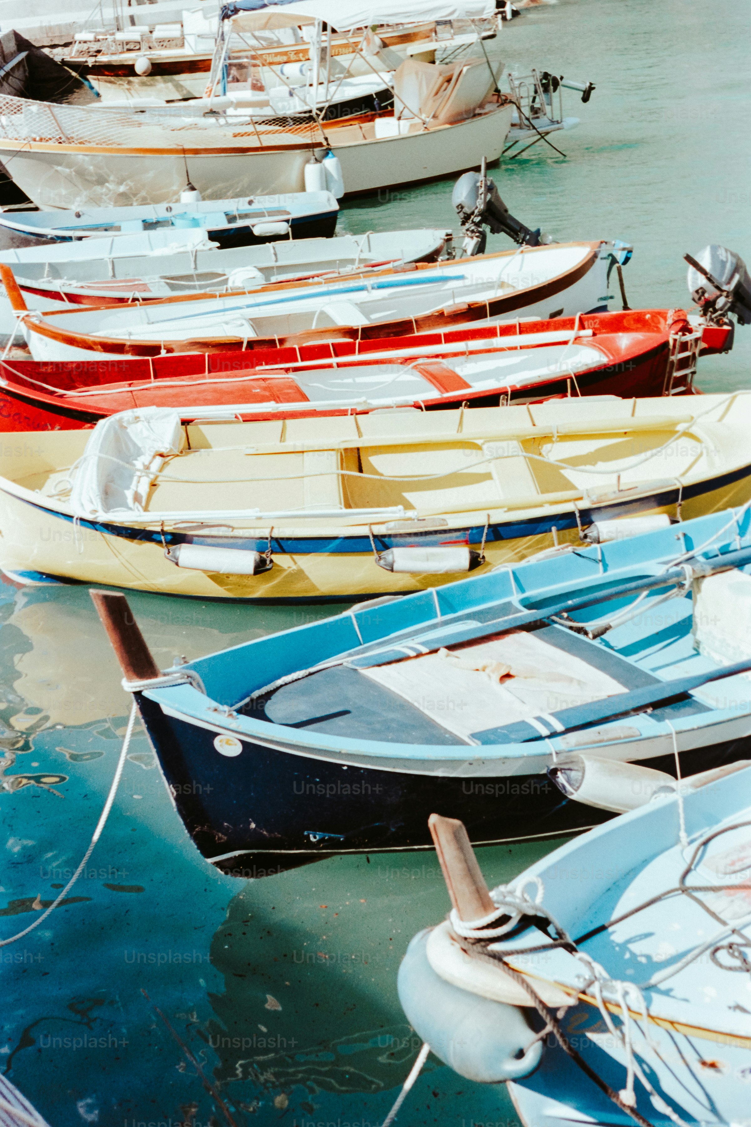 Boats are docked in a colorful harbor.