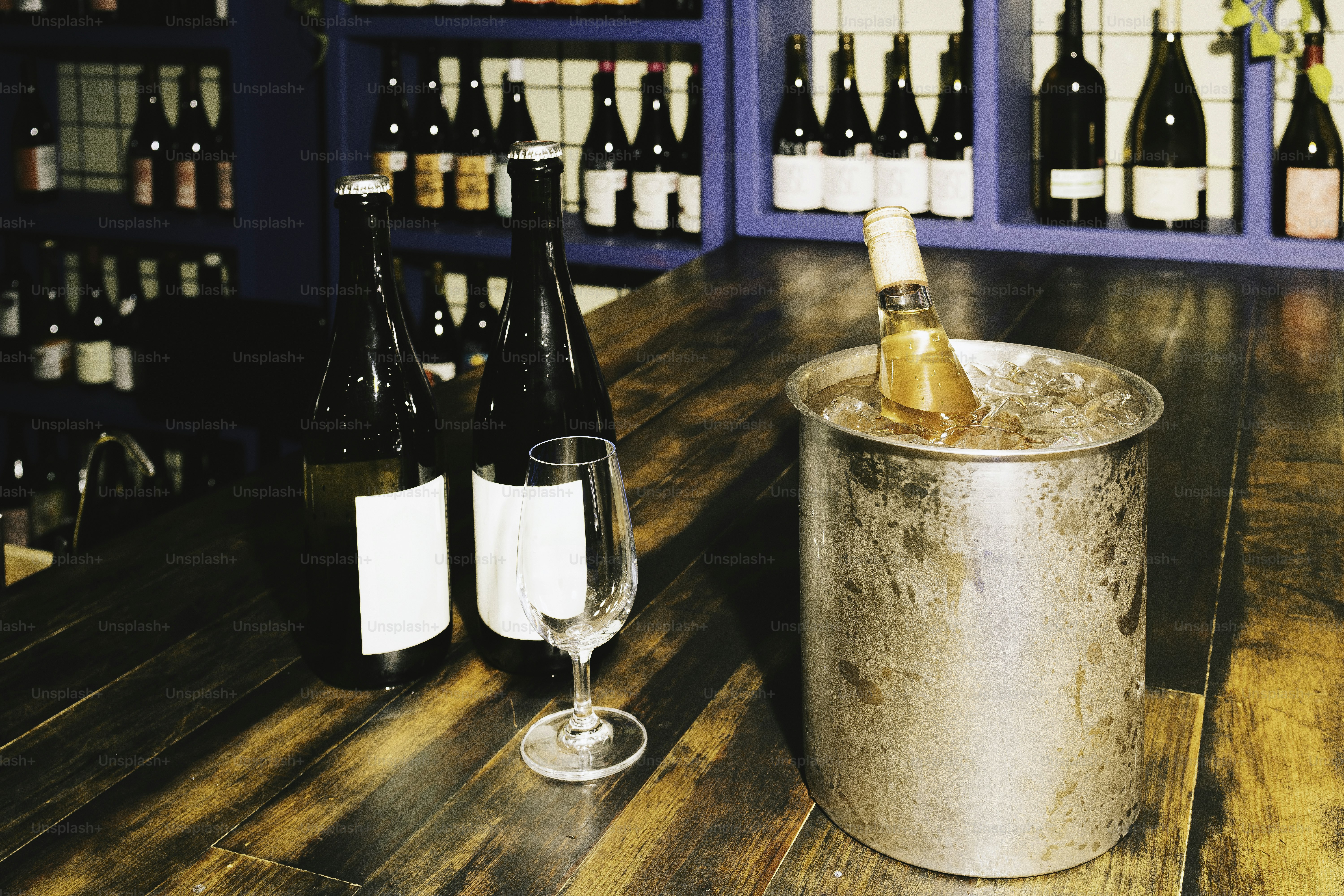 Wine bottles and a chilled beverage are on display.