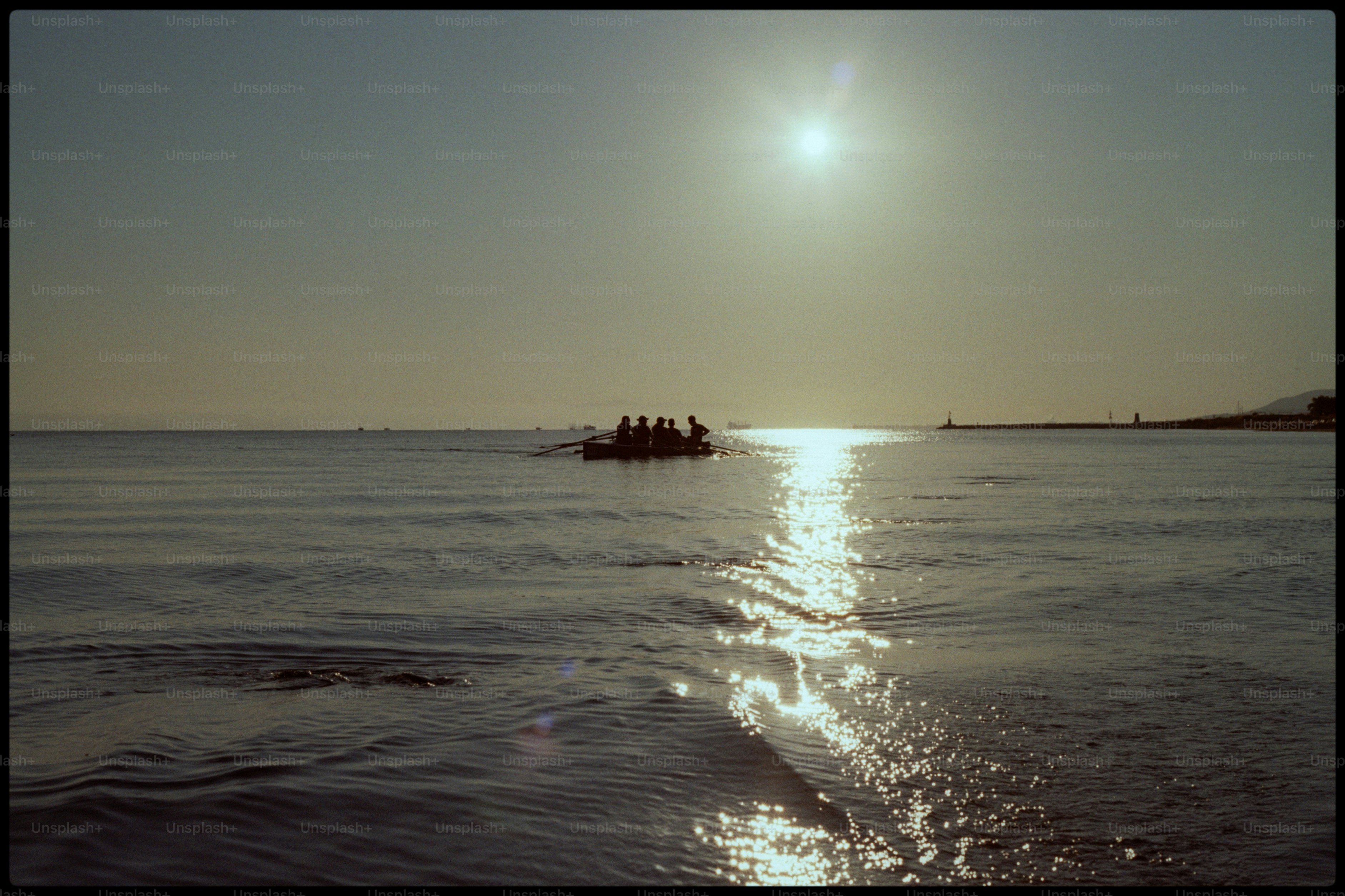 A boat sails on water under the sun