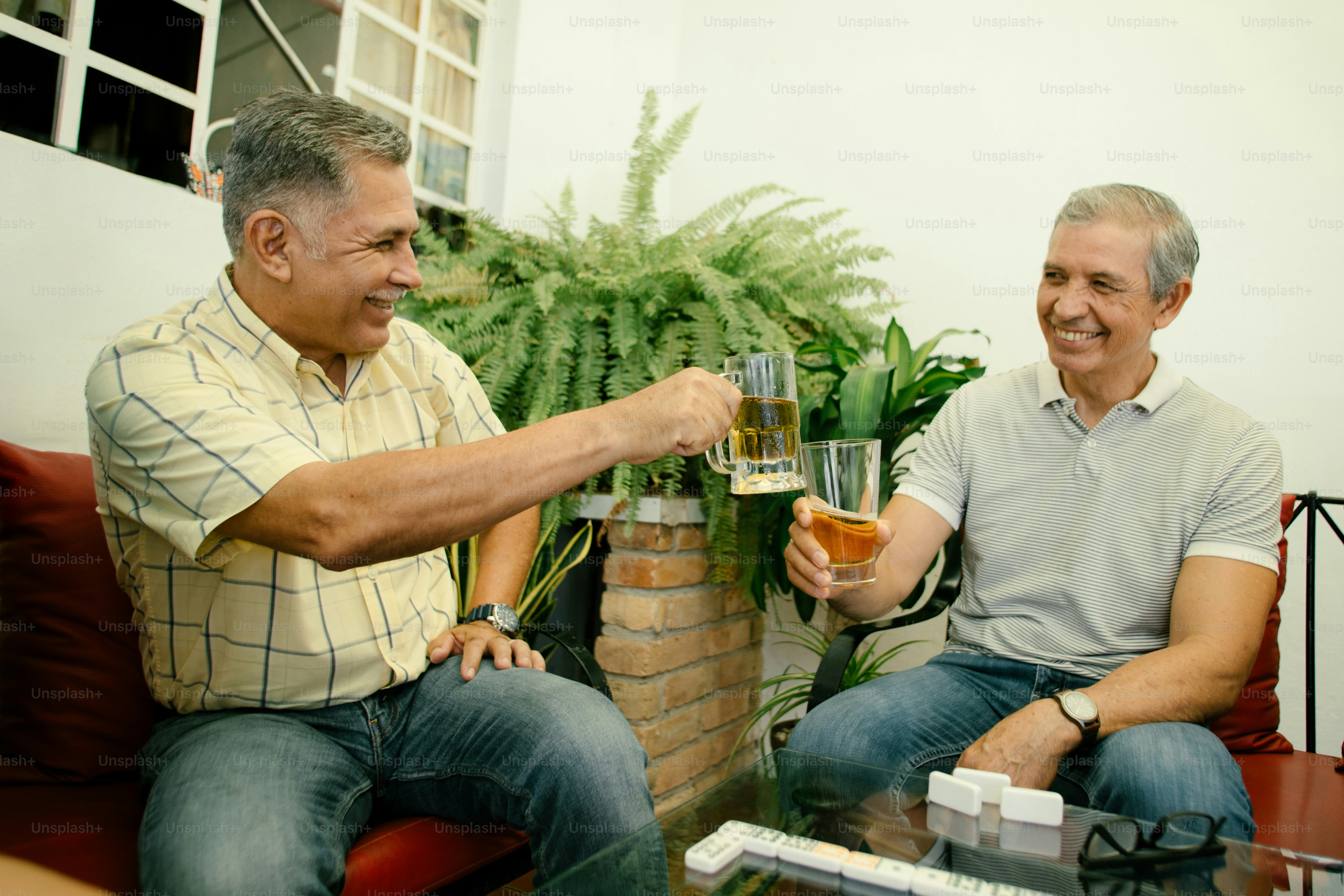 Friends are toasting beer together and smiling.