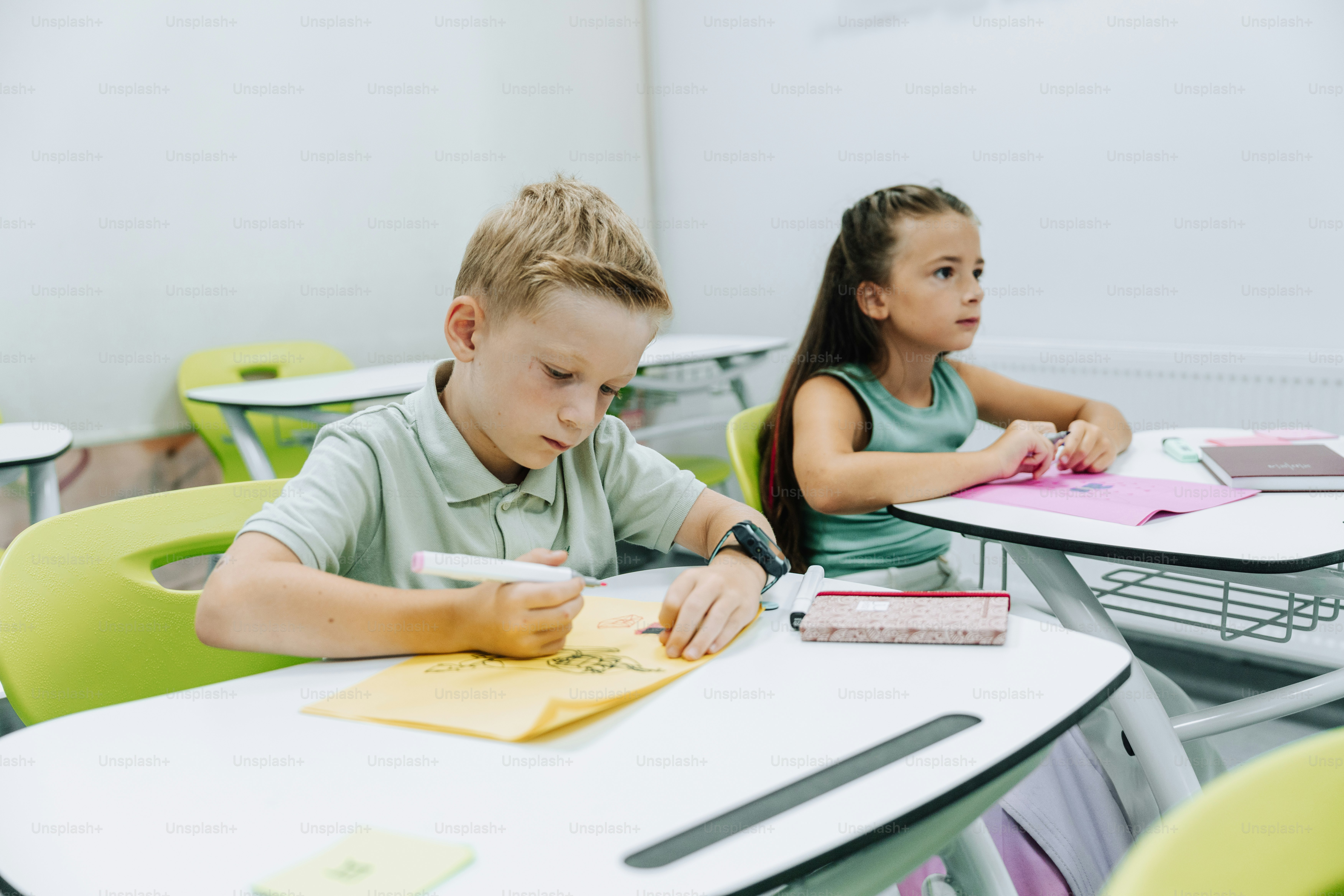 Students are in the classroom, studying and writing.