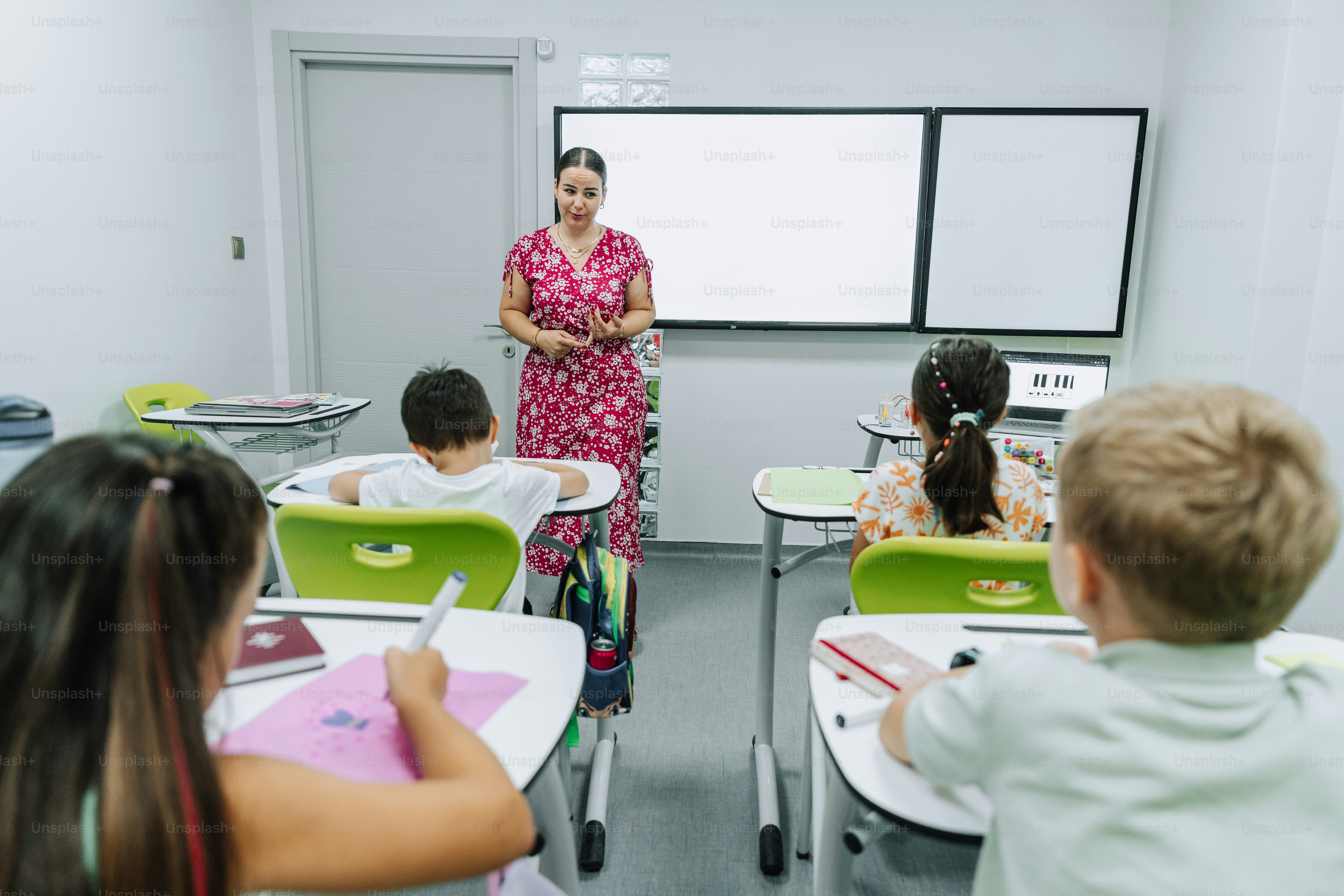 A teacher is instructing students in a classroom.
