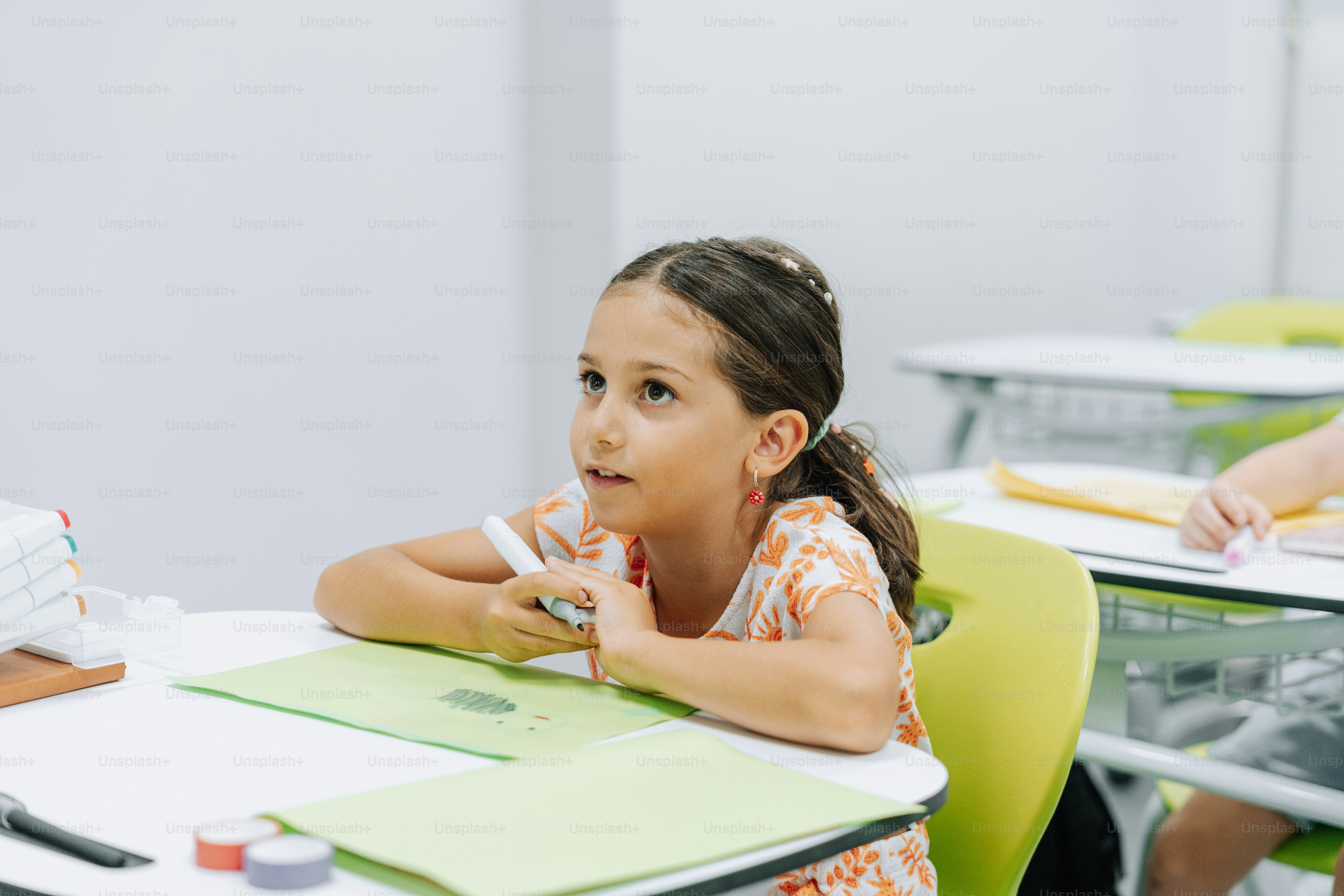 A young student is focused at her desk.