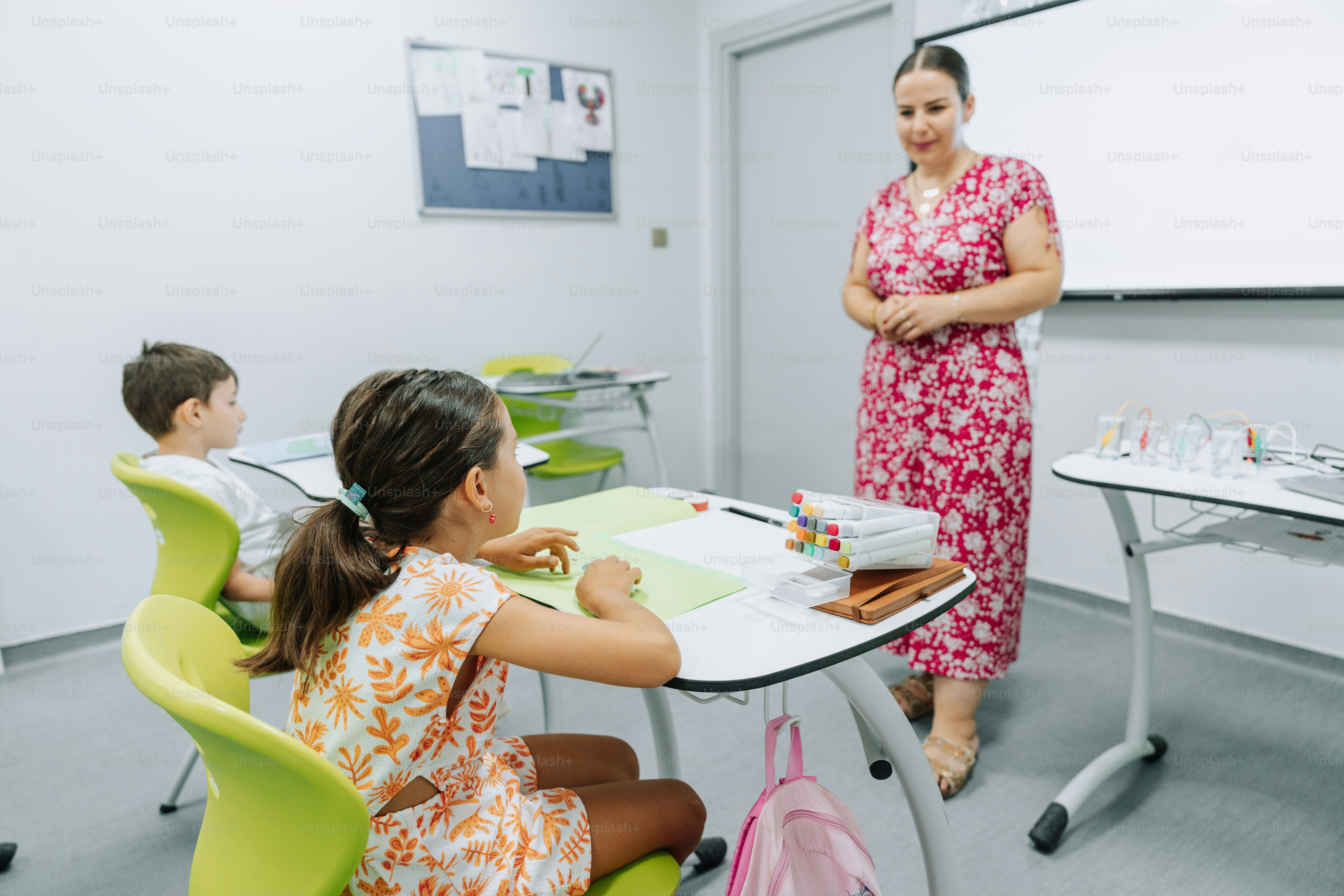 A teacher is instructing students in a classroom.