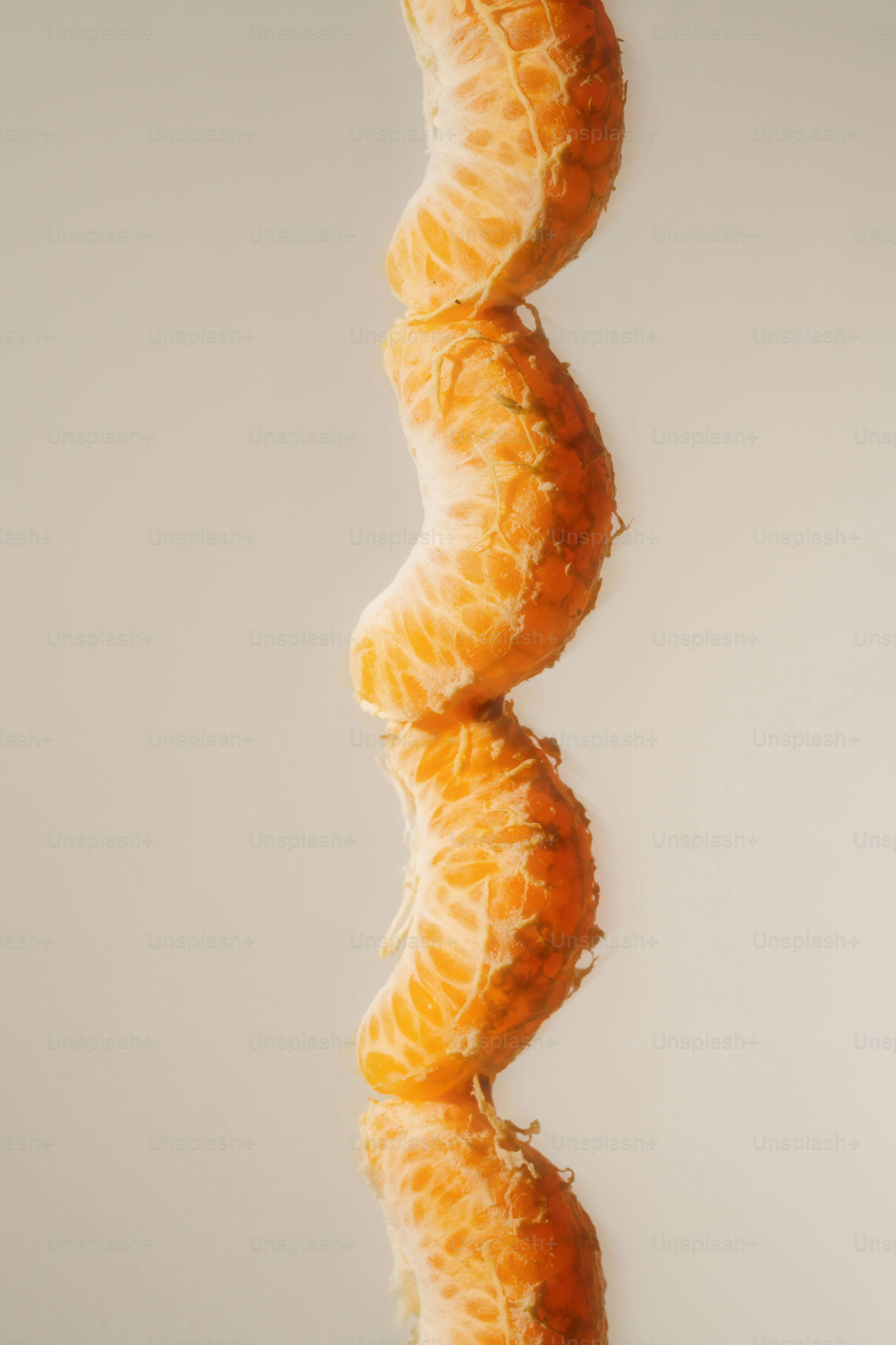 Tangerine segments stacked in an artful tower.