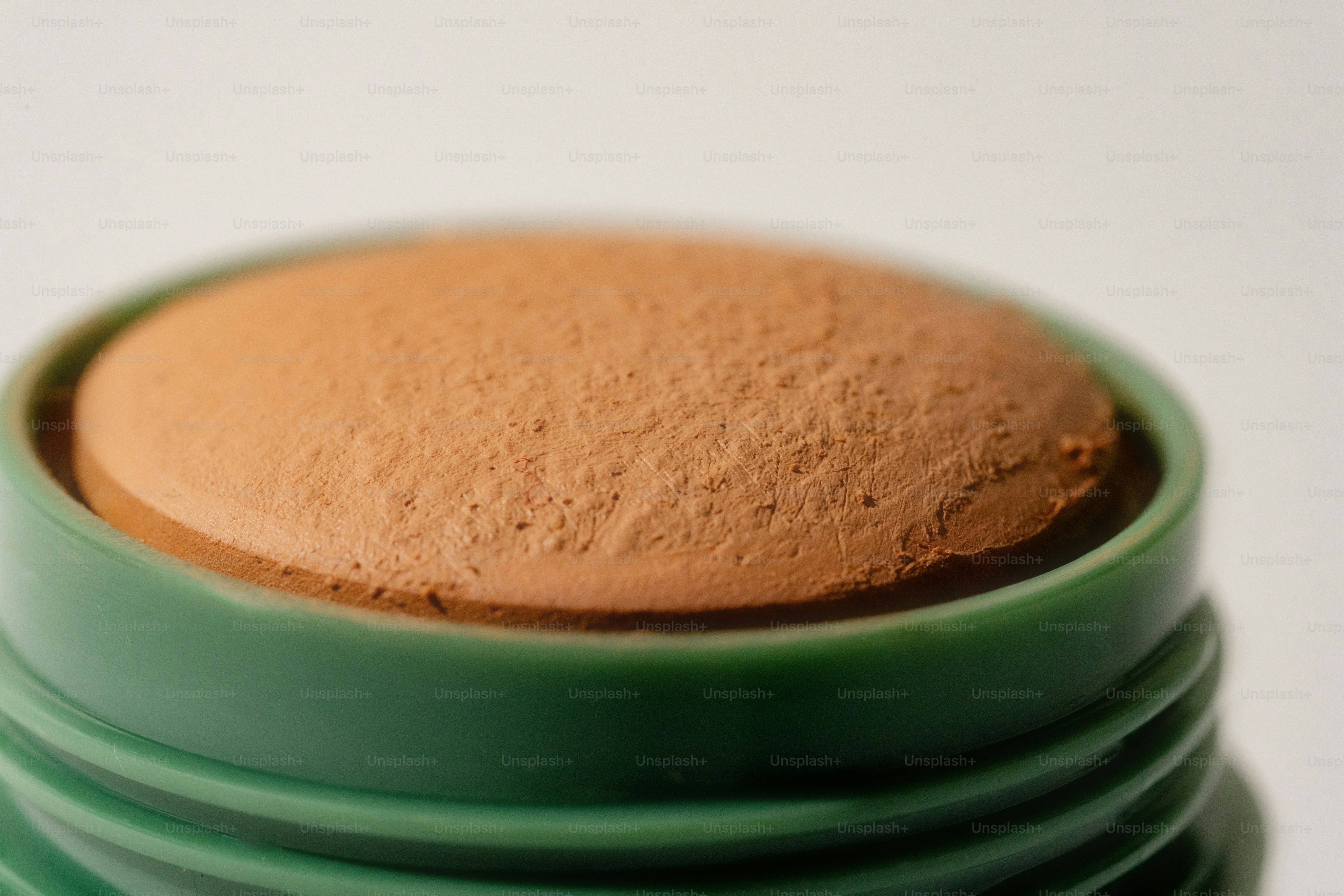A close-up of a brown makeup stick.