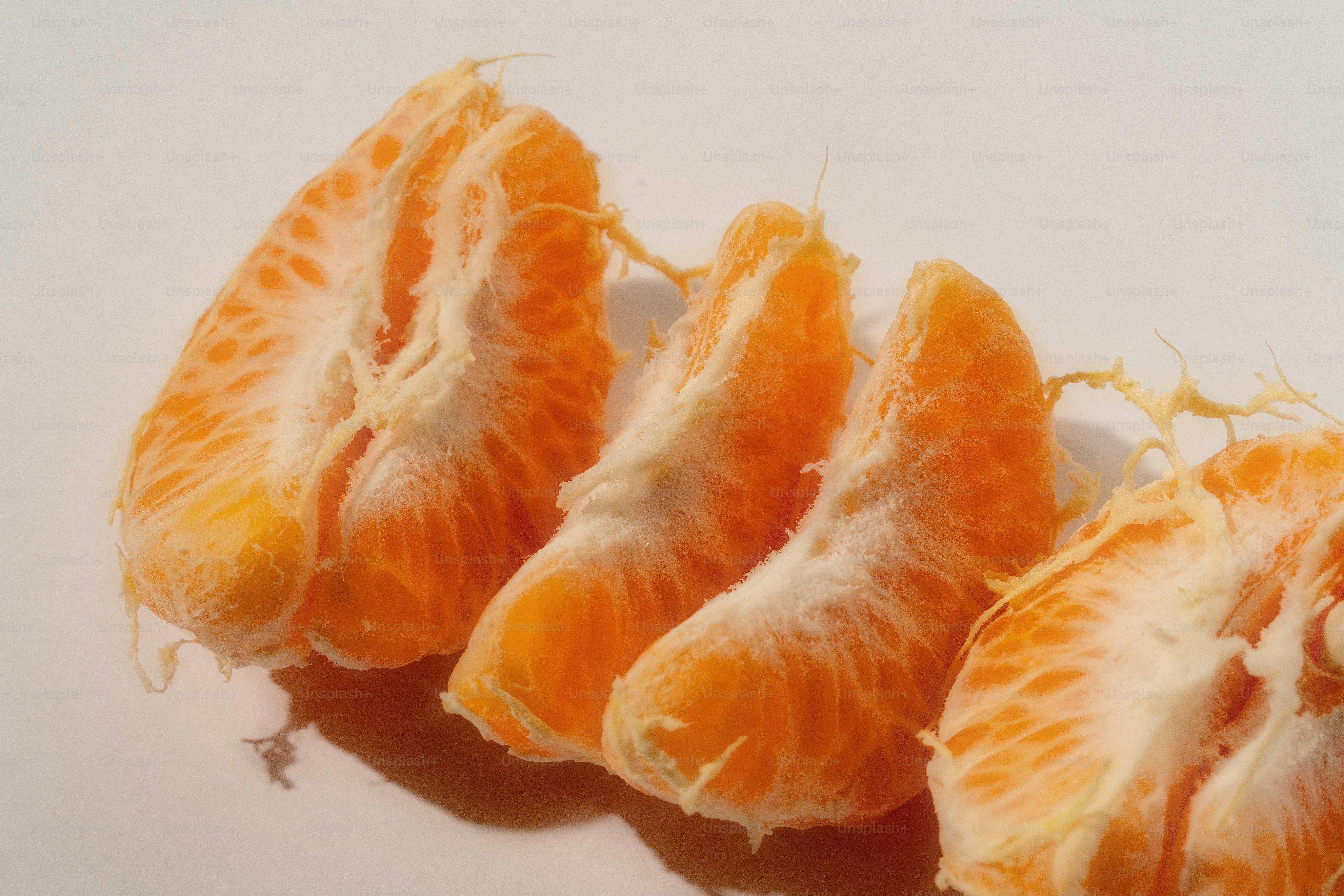 Tangerine segments arranged in a line.