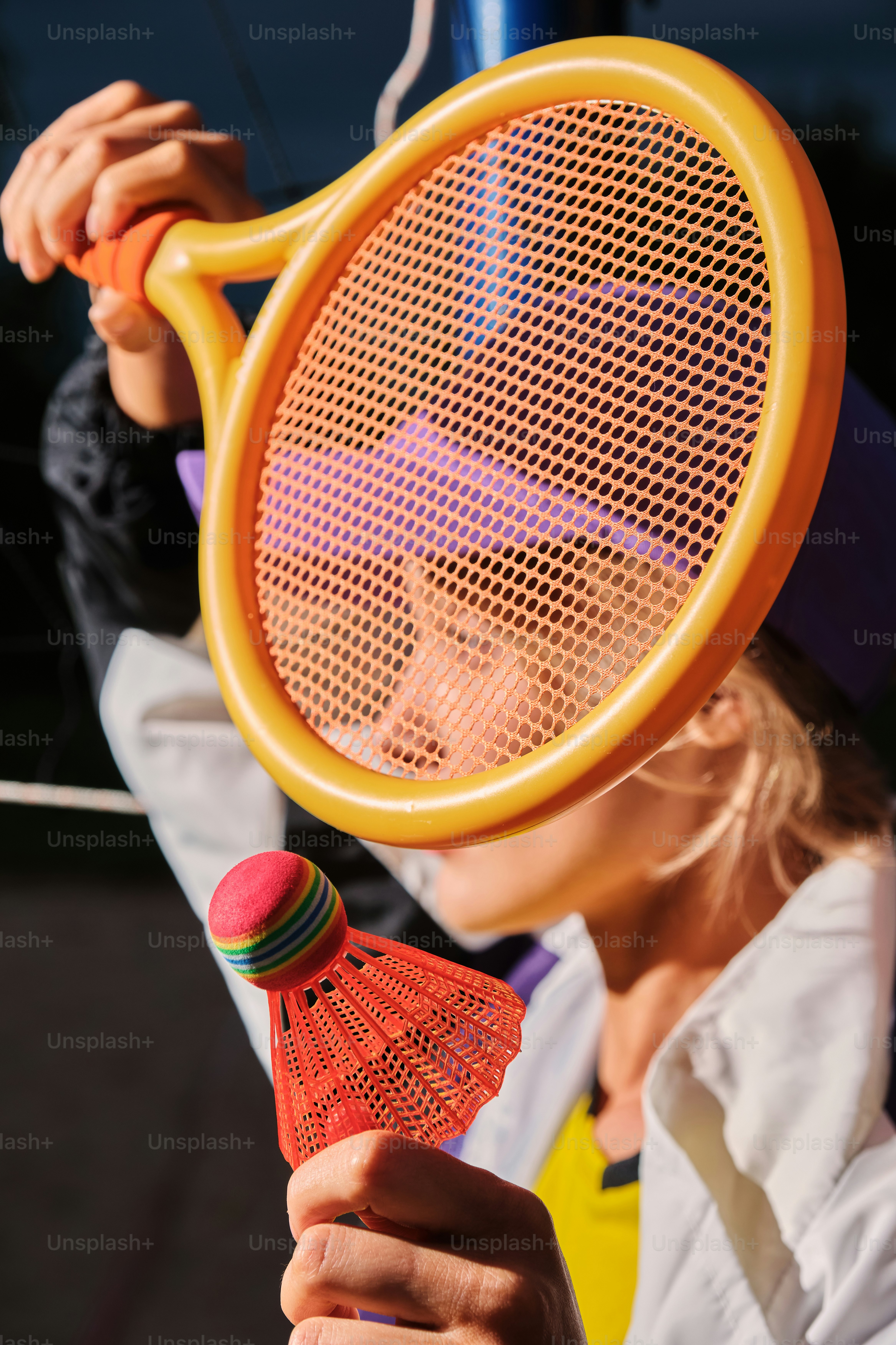 A person plays badminton with a giant racket. photo – Woman Image on ...