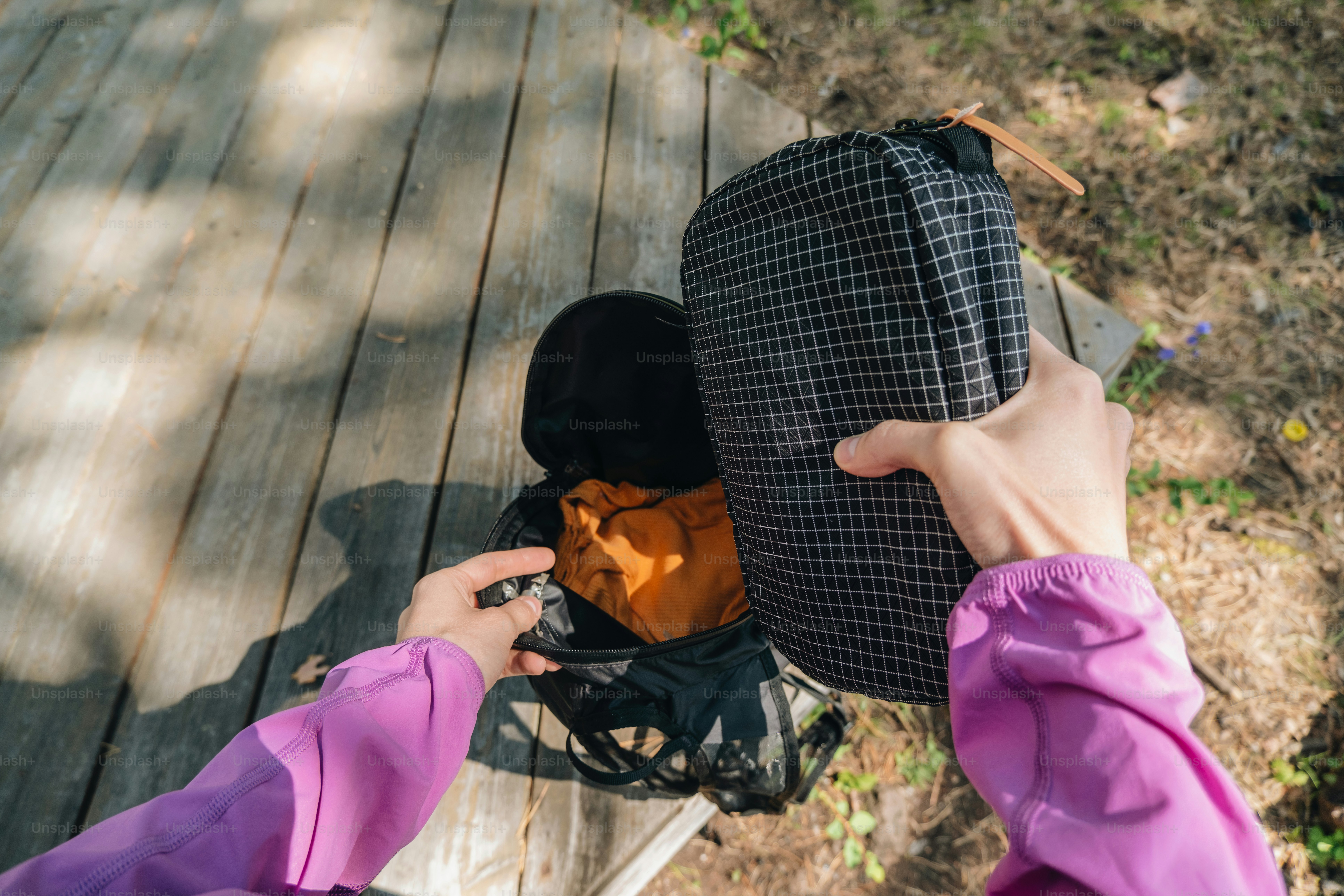 Unpacking a backpack with camping gear.