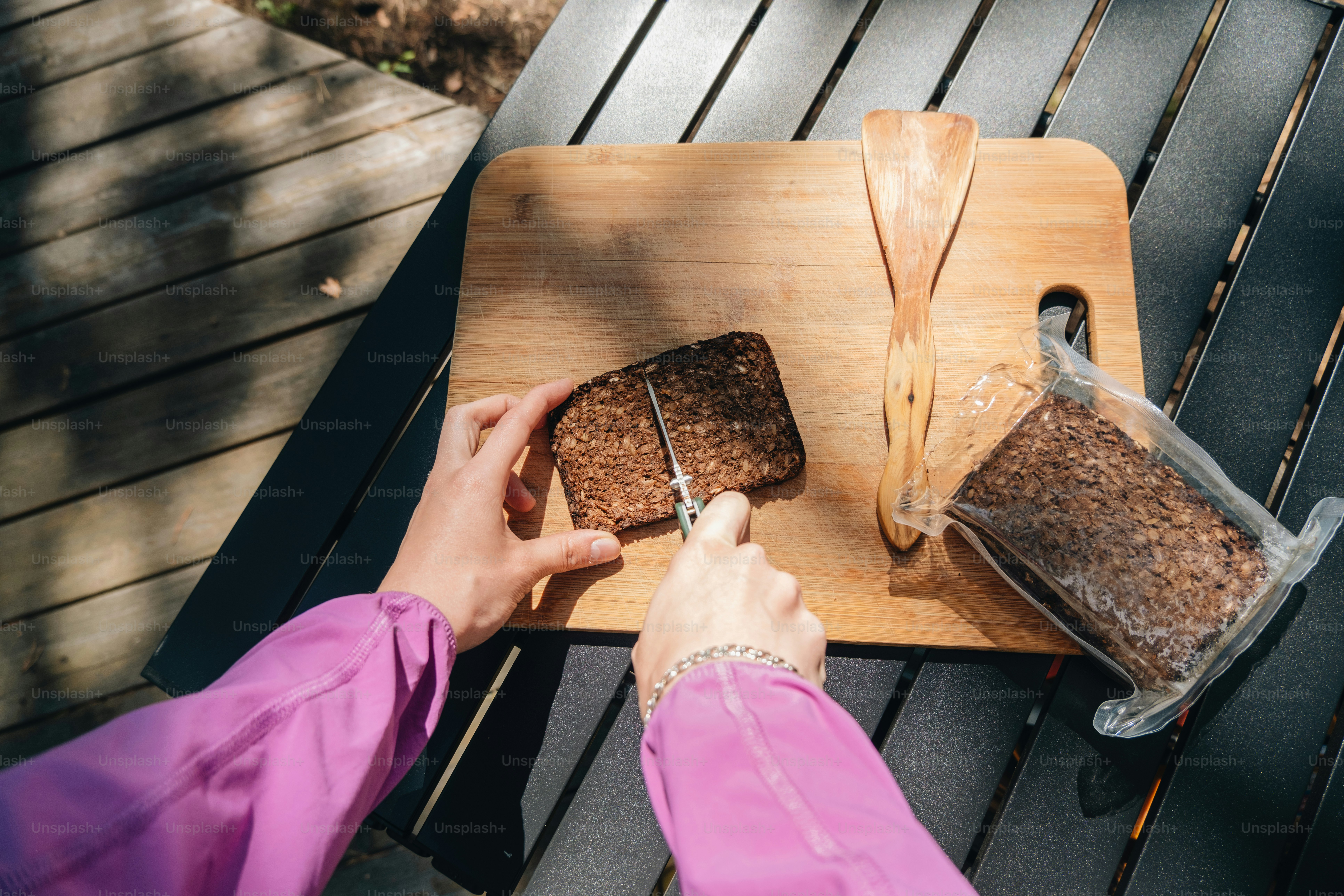 Someone is slicing a block of food with a knife. photo – Woman Image on ...