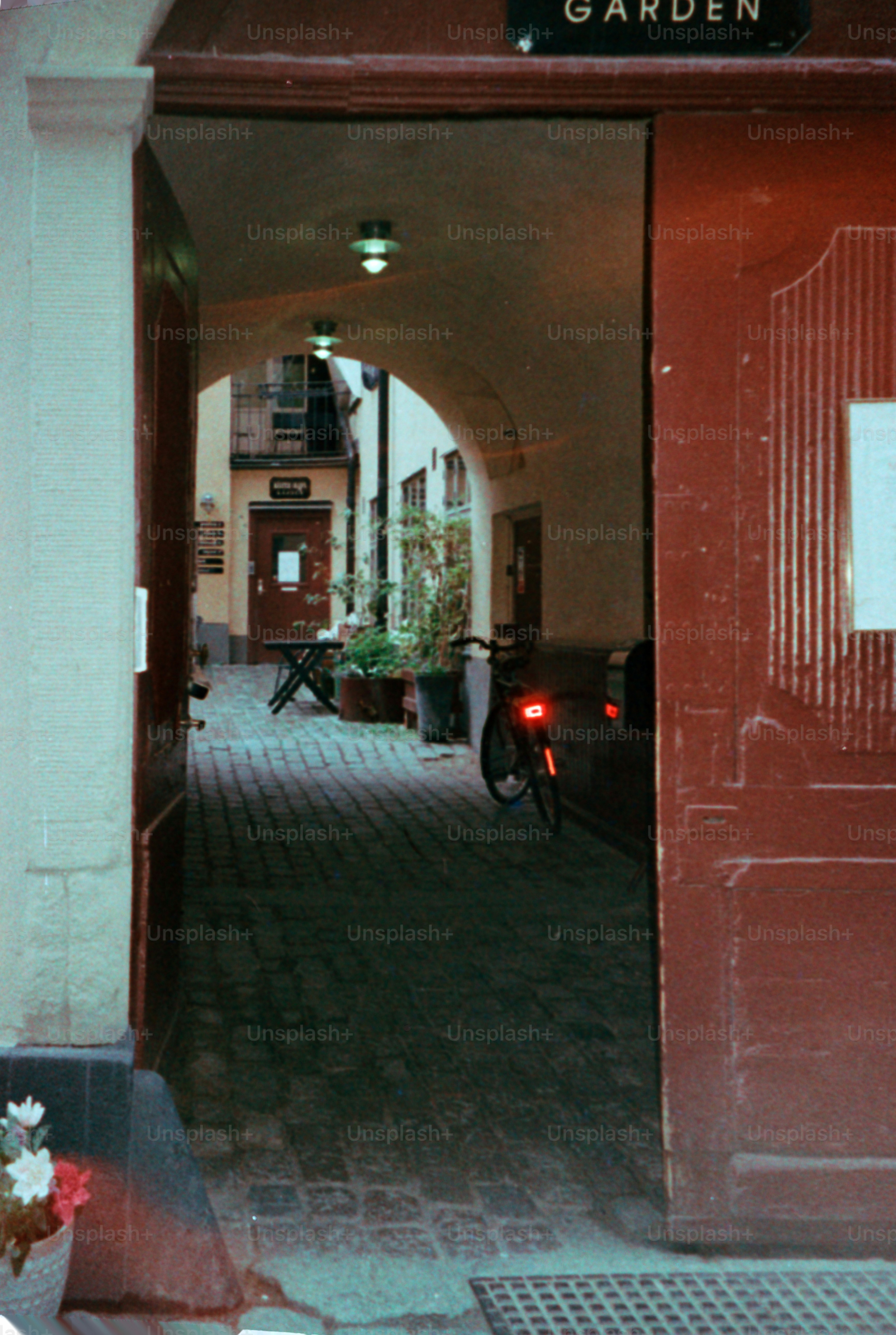 An arched passageway leads to a quiet garden.