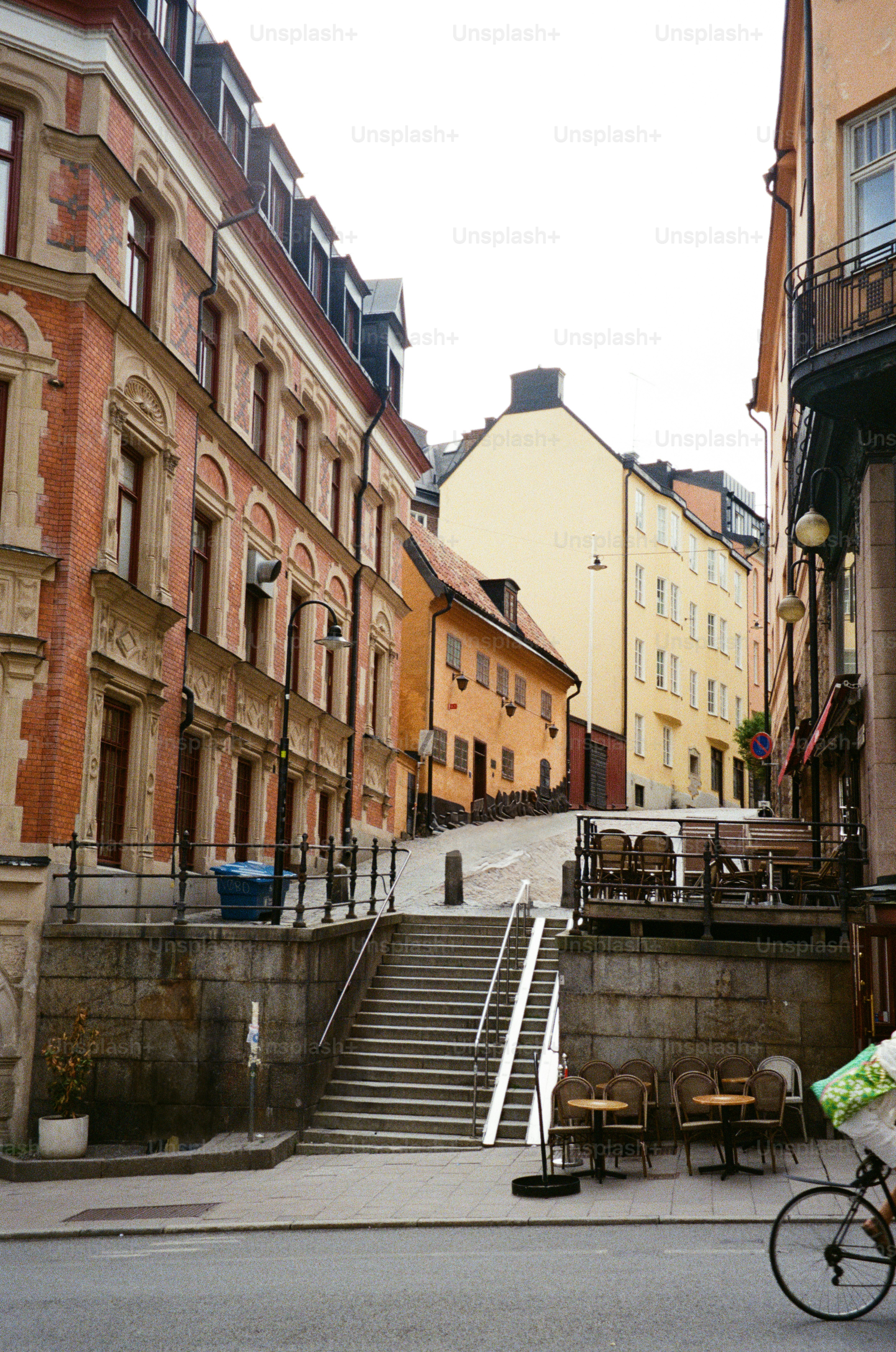A narrow street framed by colorful buildings.