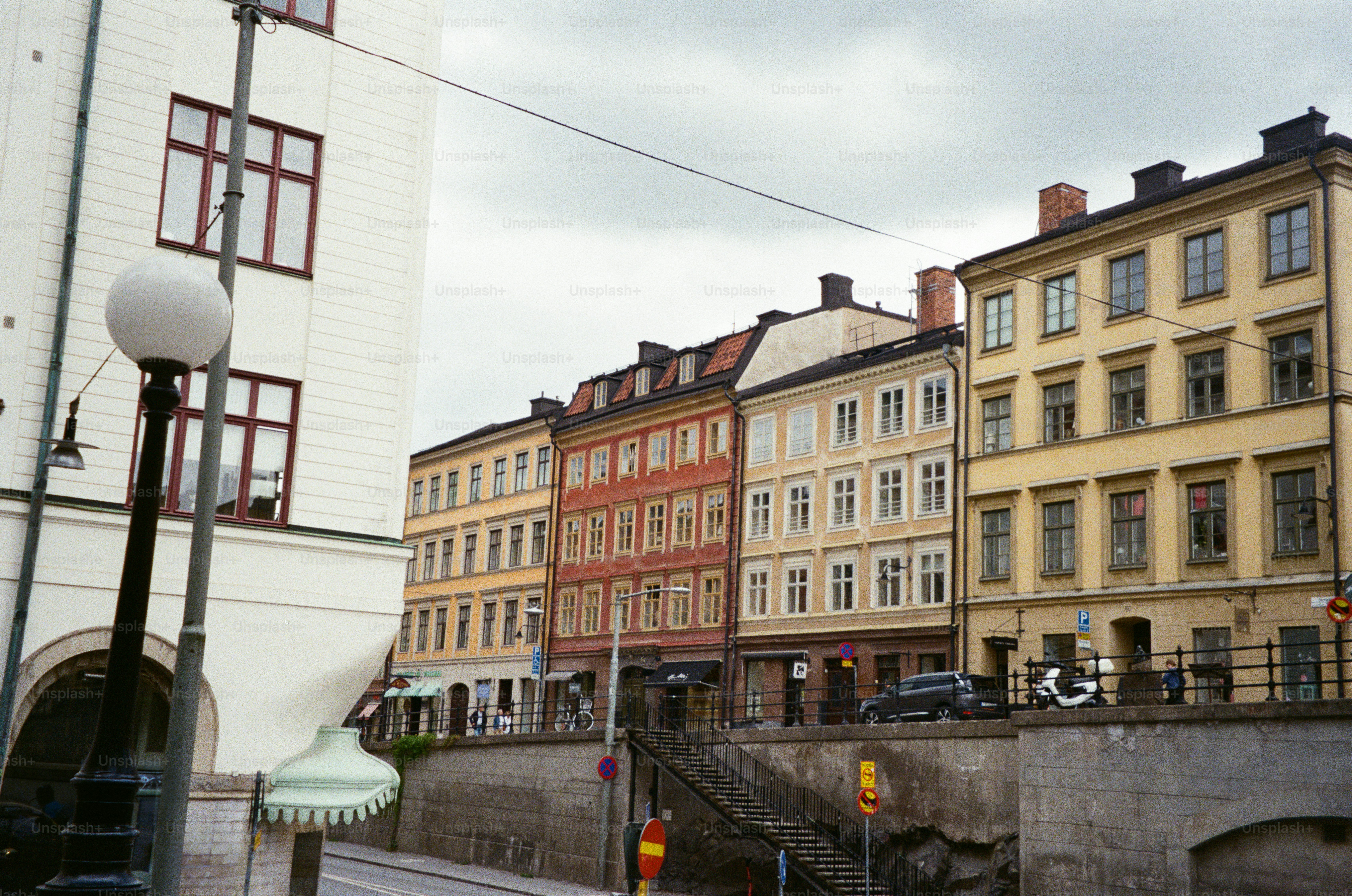 Row of colorful buildings under a cloudy sky.