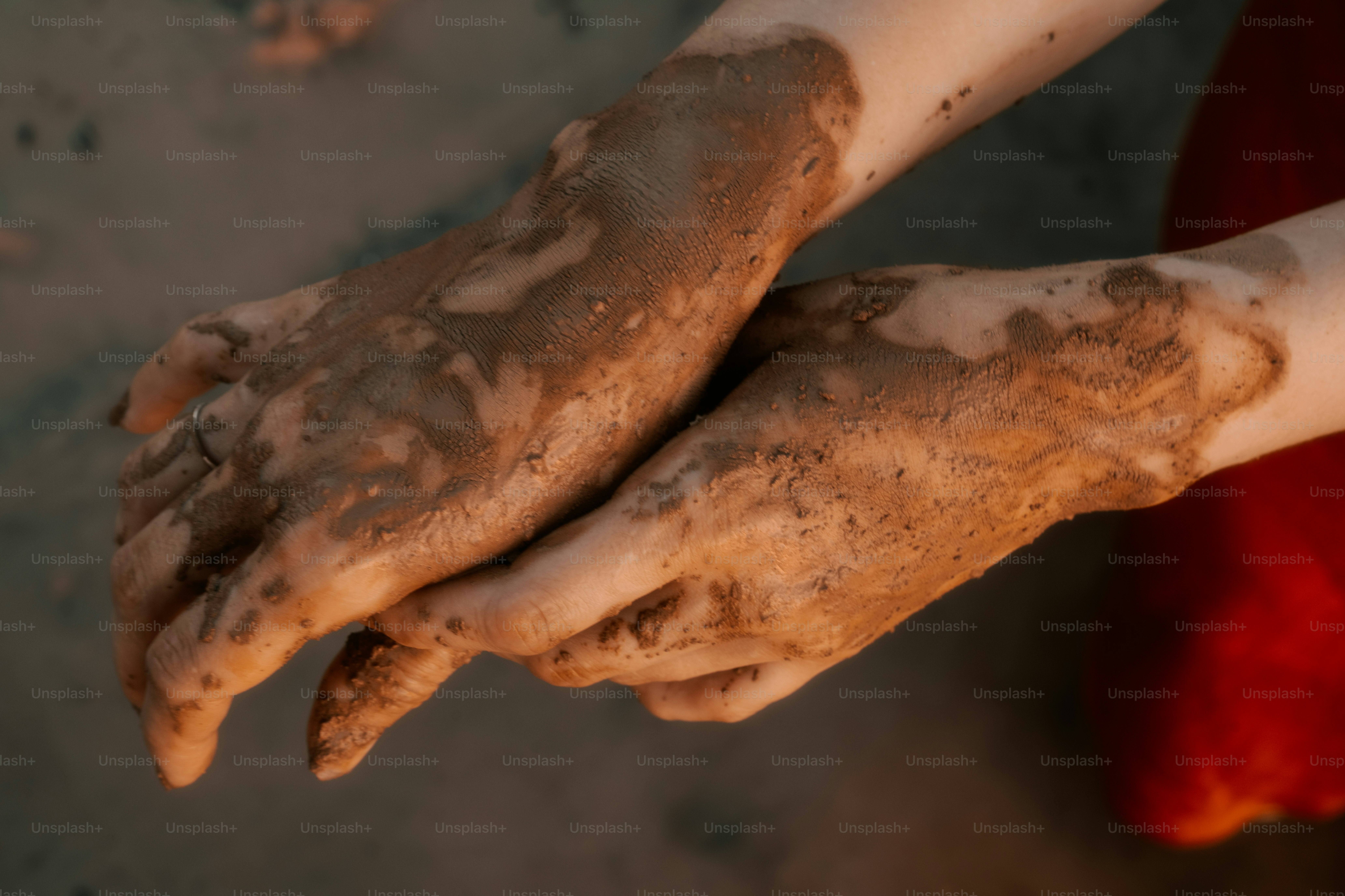 Hands are covered in mud.