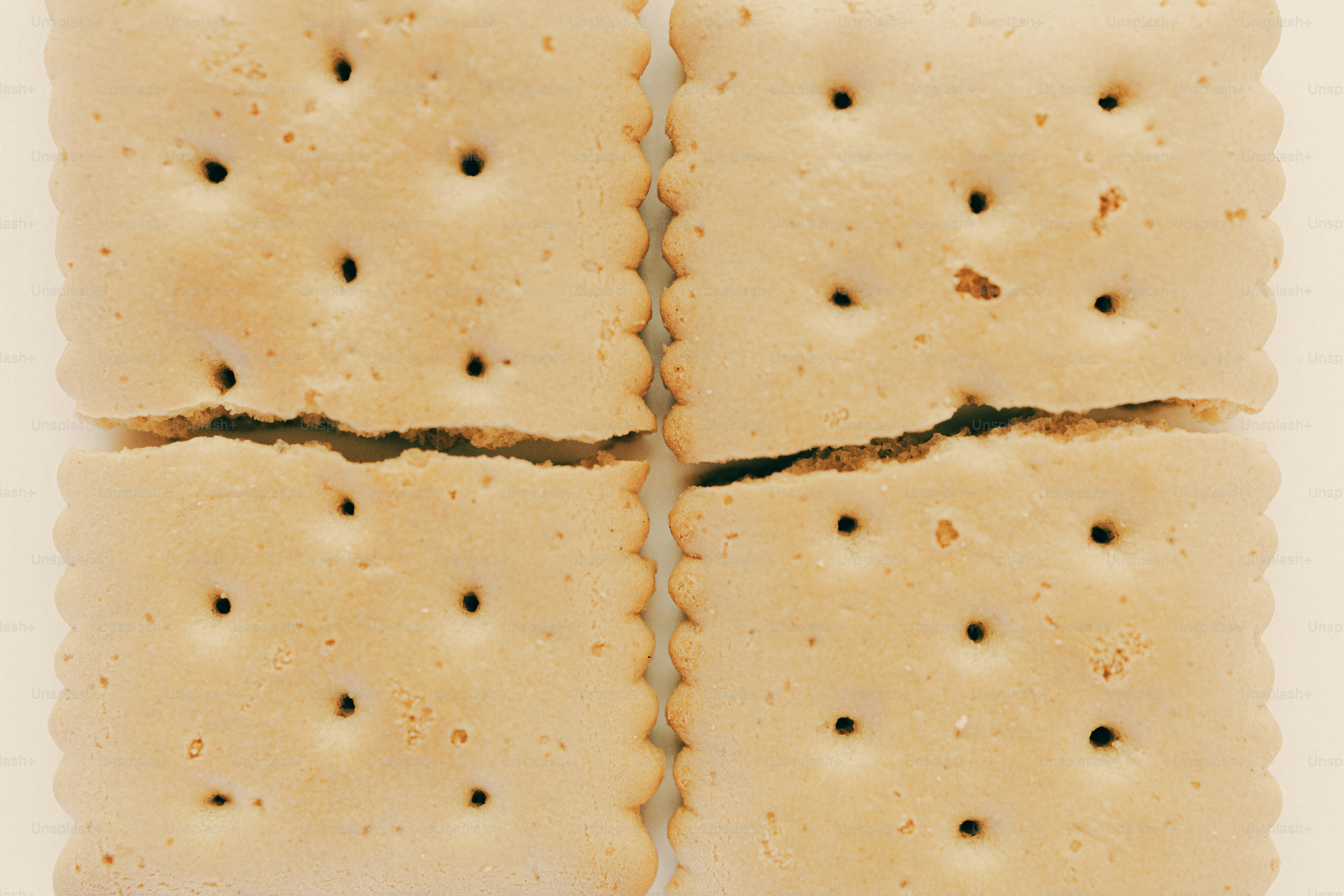 Four crackers are shown, cracking apart. photo – Minimalist Image on ...