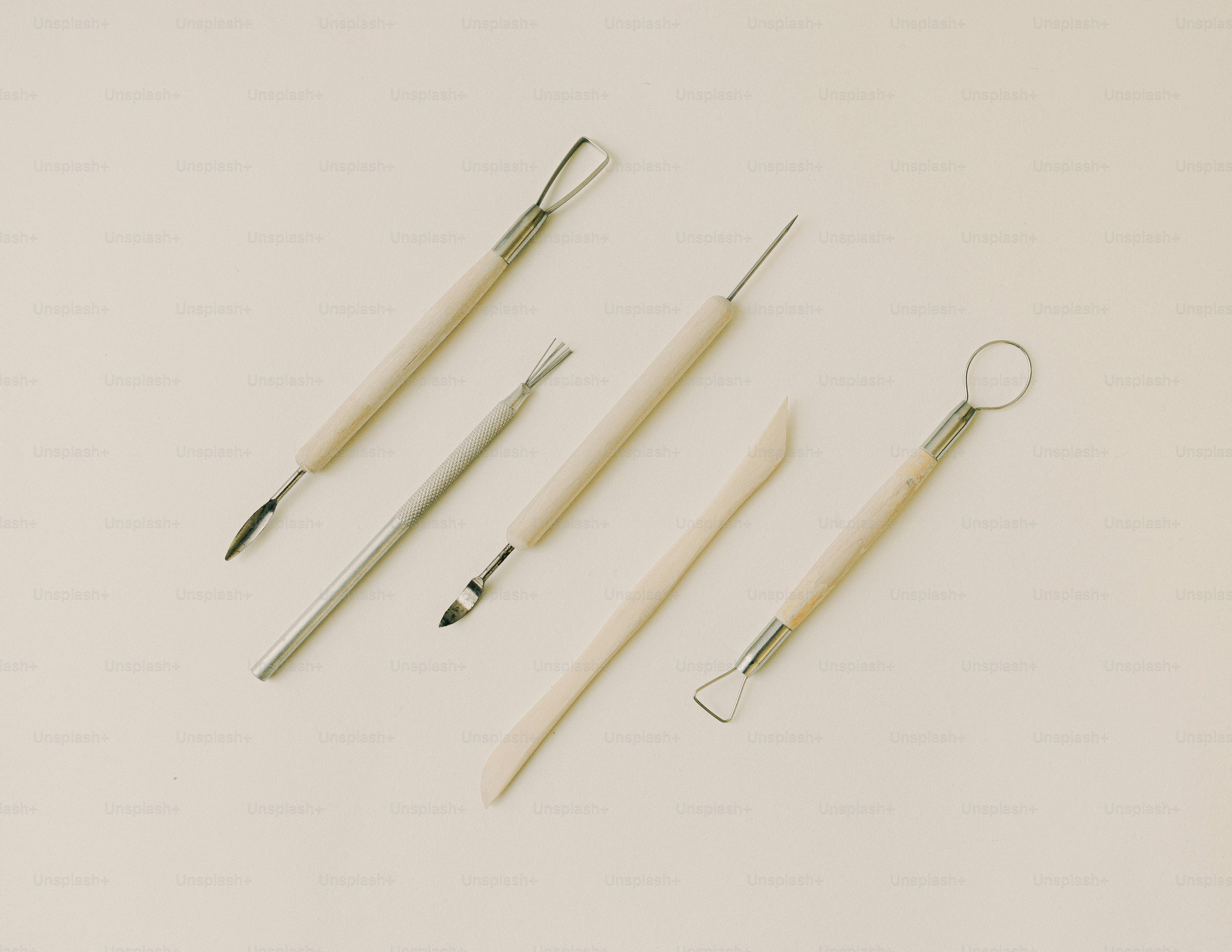 Here is a possible caption: pottery tools lay scattered on a surface.