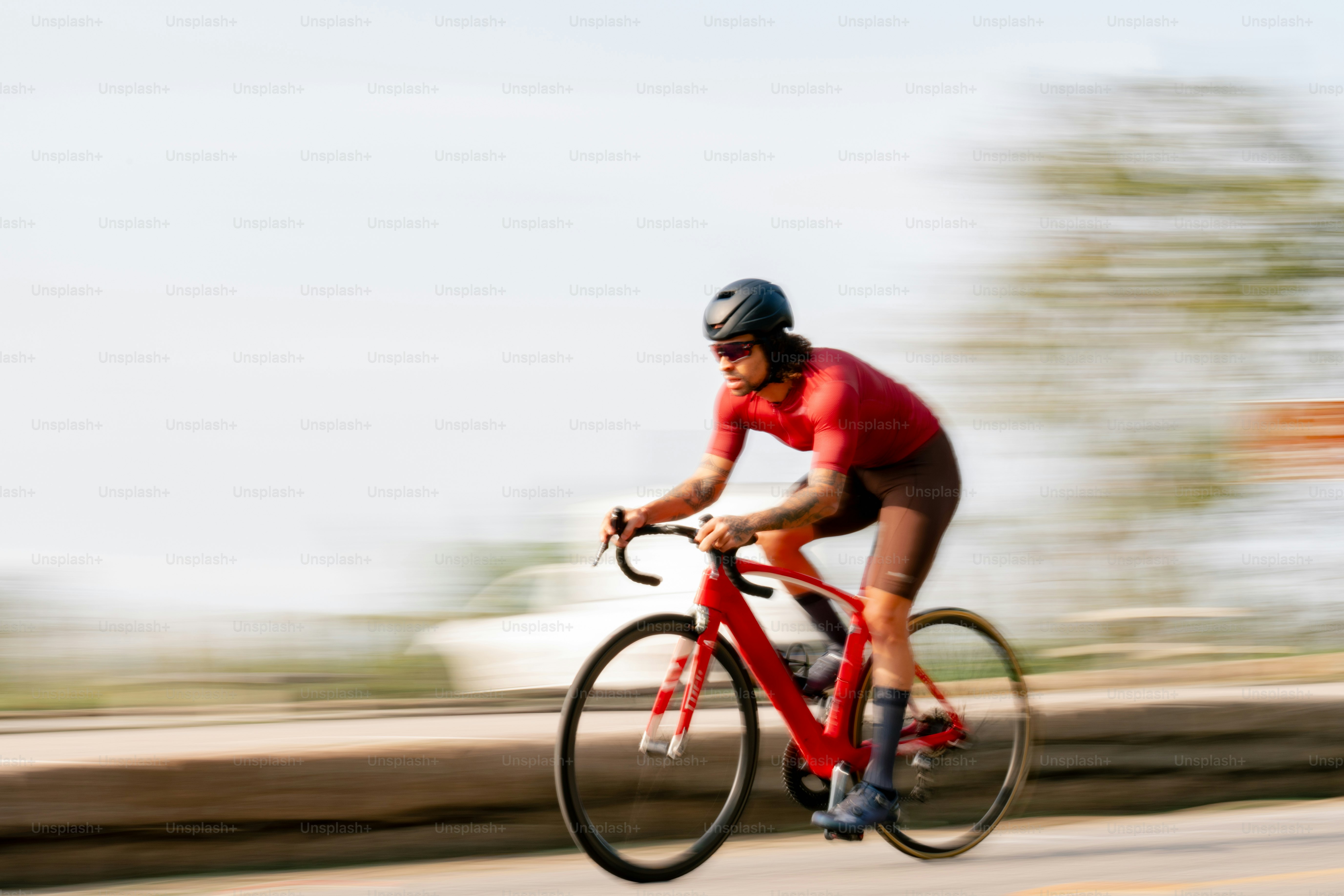 Cyclist rides a red bike on the road. photo – Sport Image on Unsplash