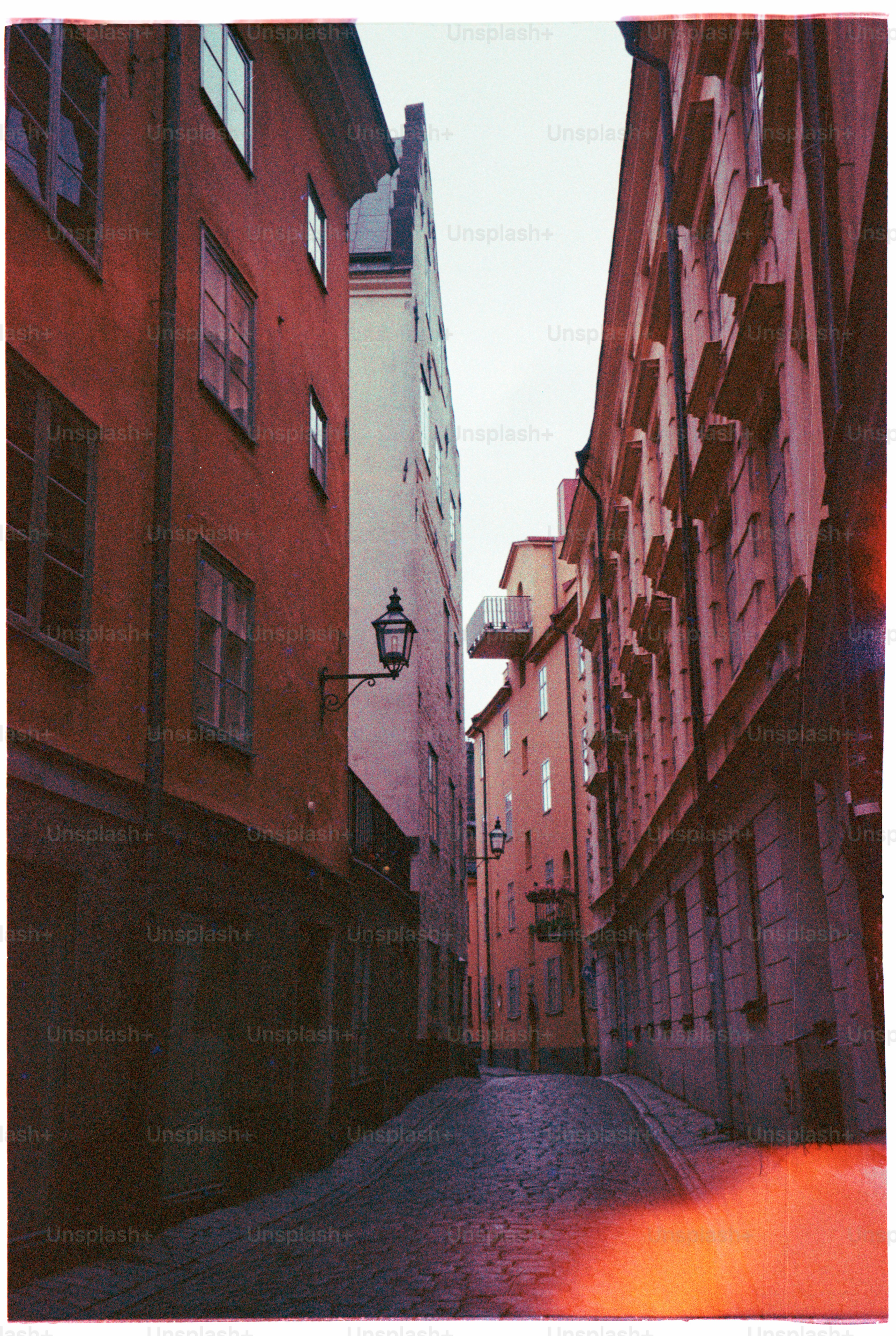 A narrow street between colorful buildings.