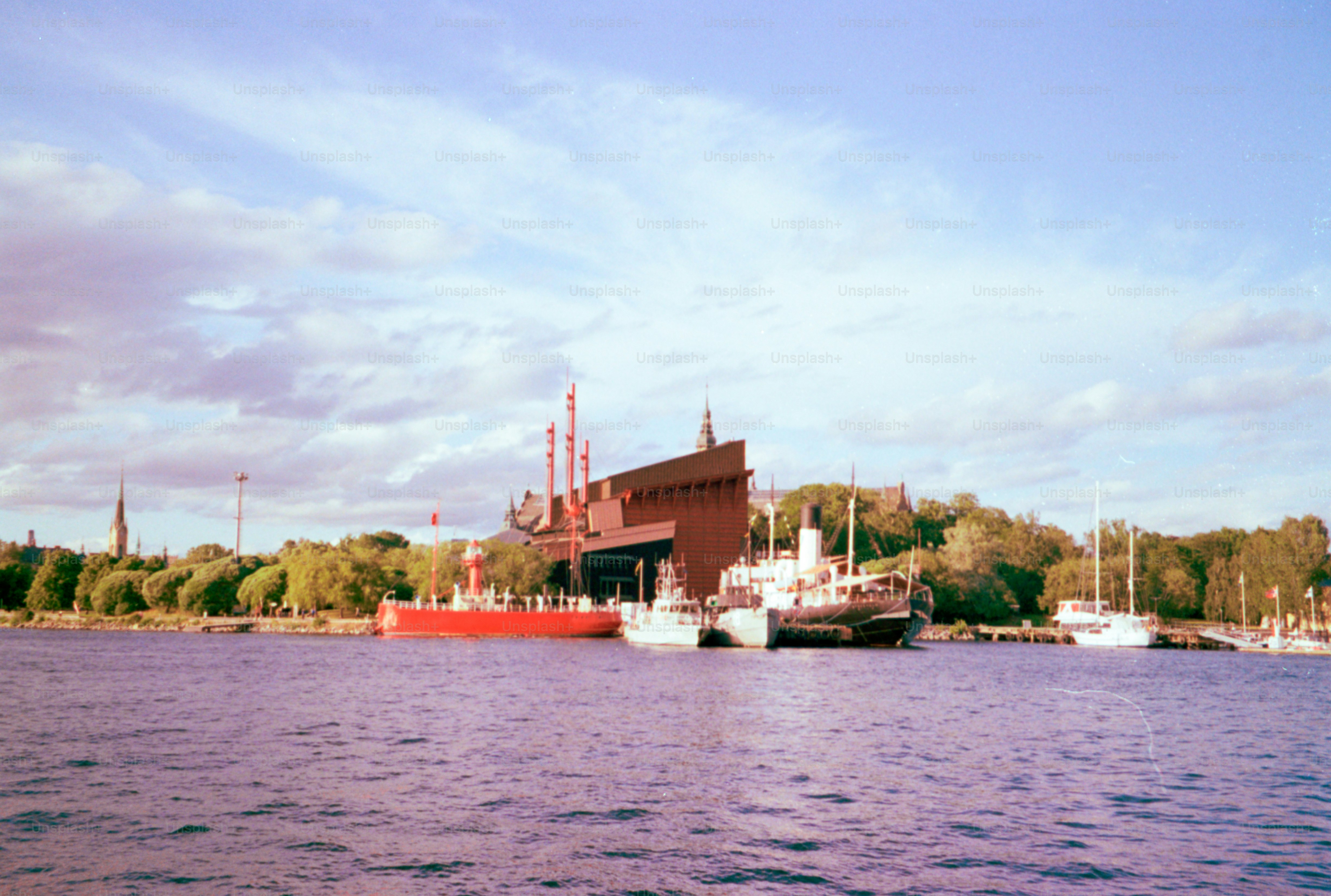 Um edifício industrial e barcos na água.