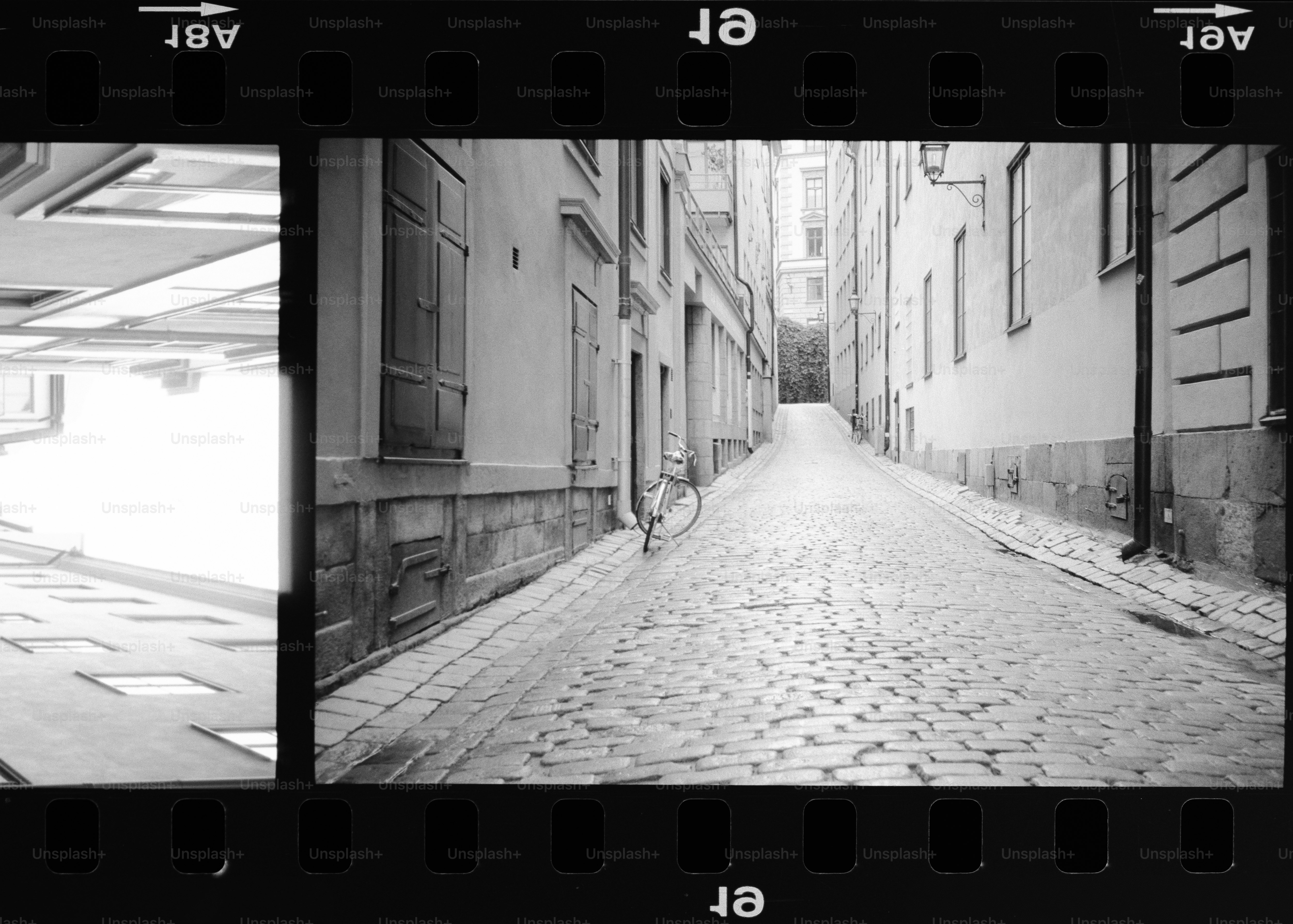Stretta strada acciottolata incorniciata da edifici.