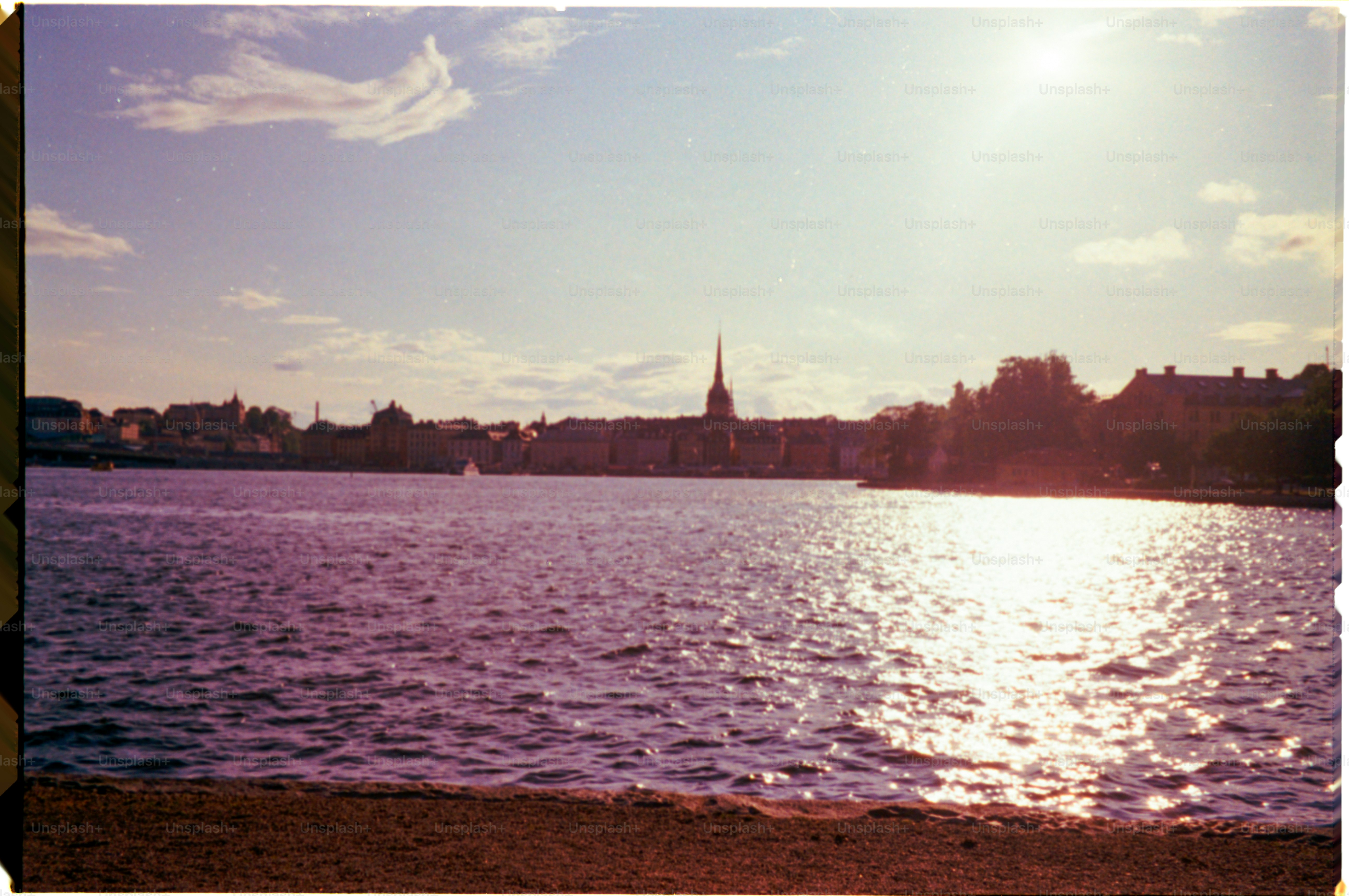 A shimmering lake reflects a skyline.