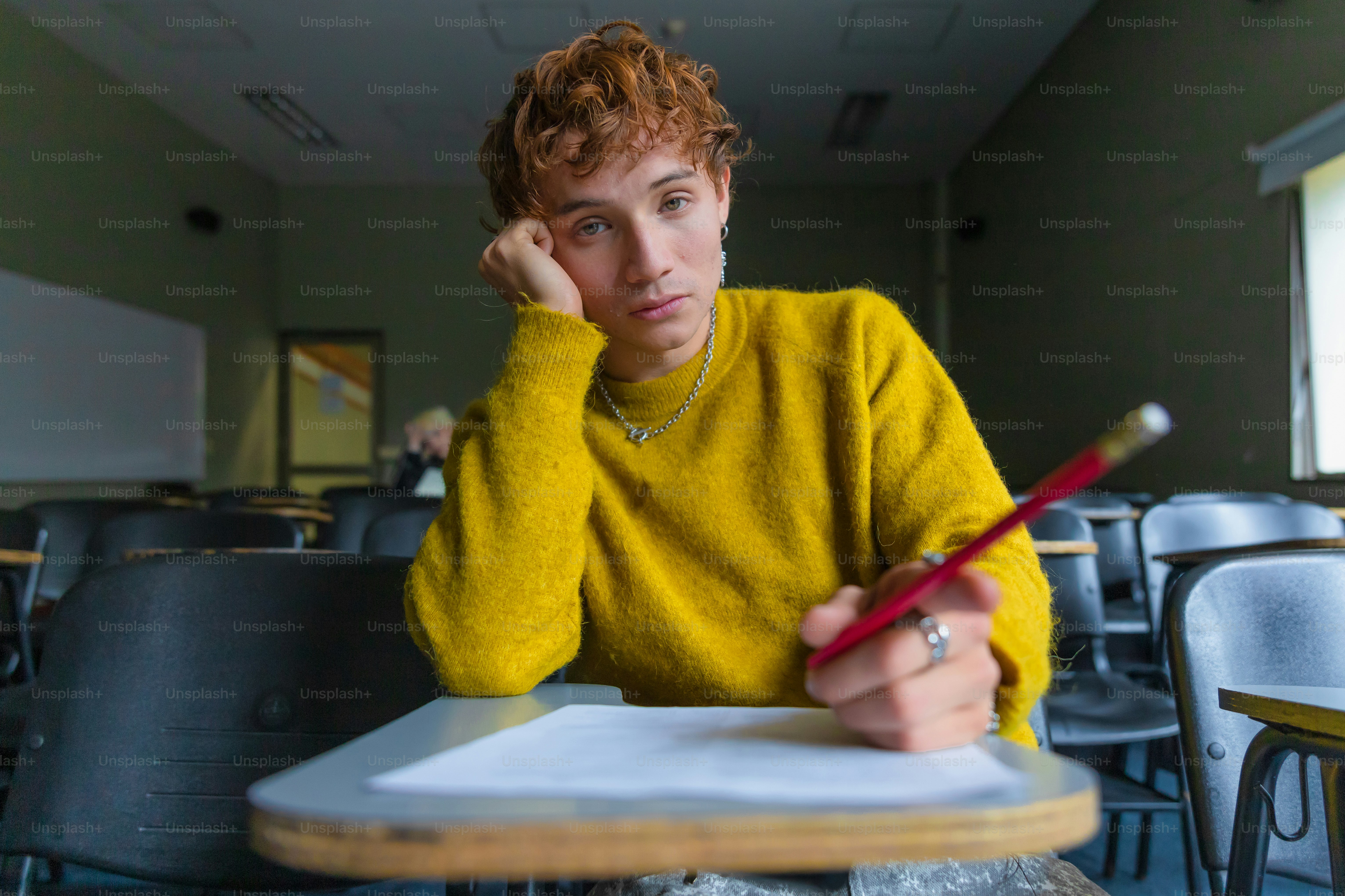 Bored student studies in a classroom.