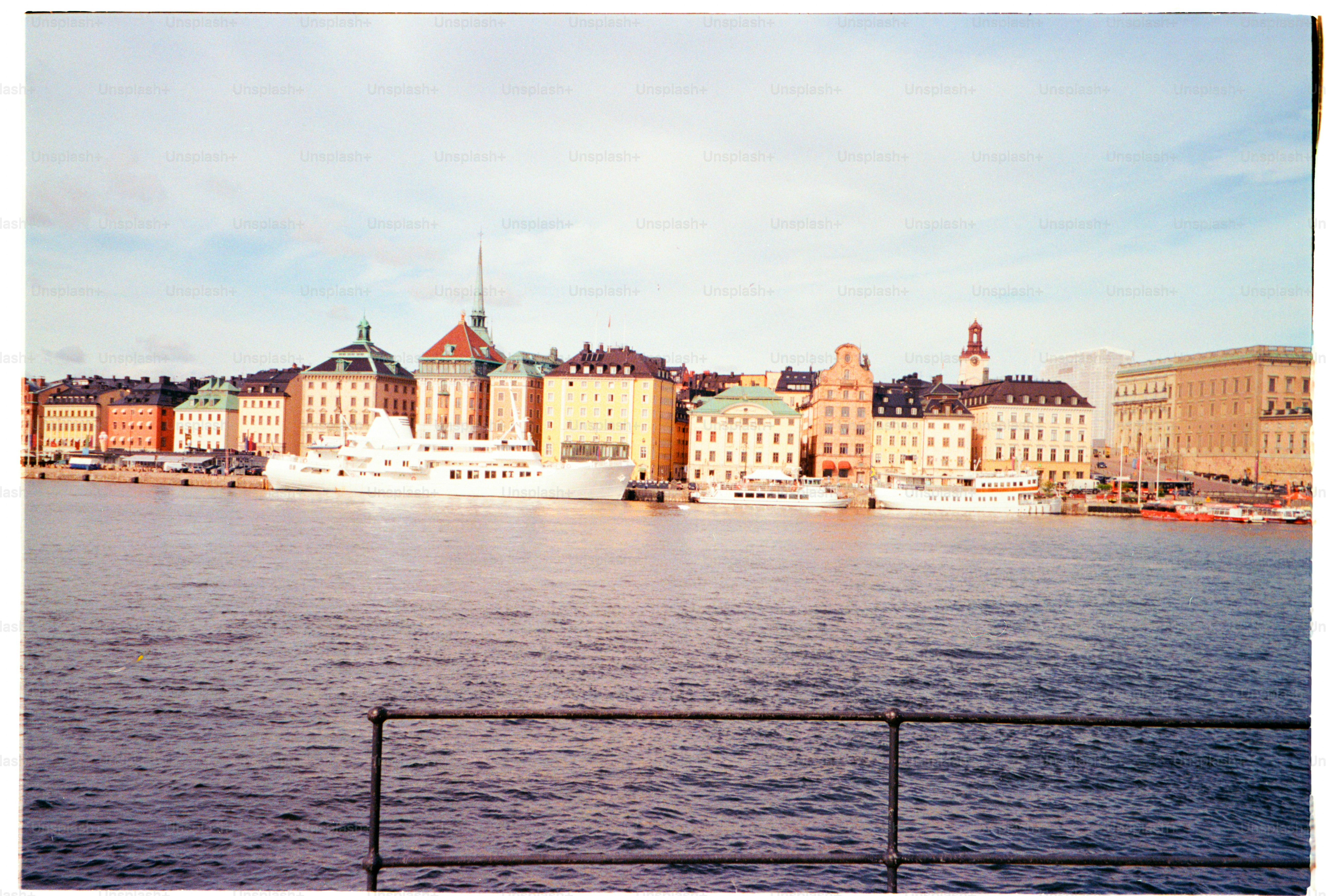 A cityscape is next to the water with boats.