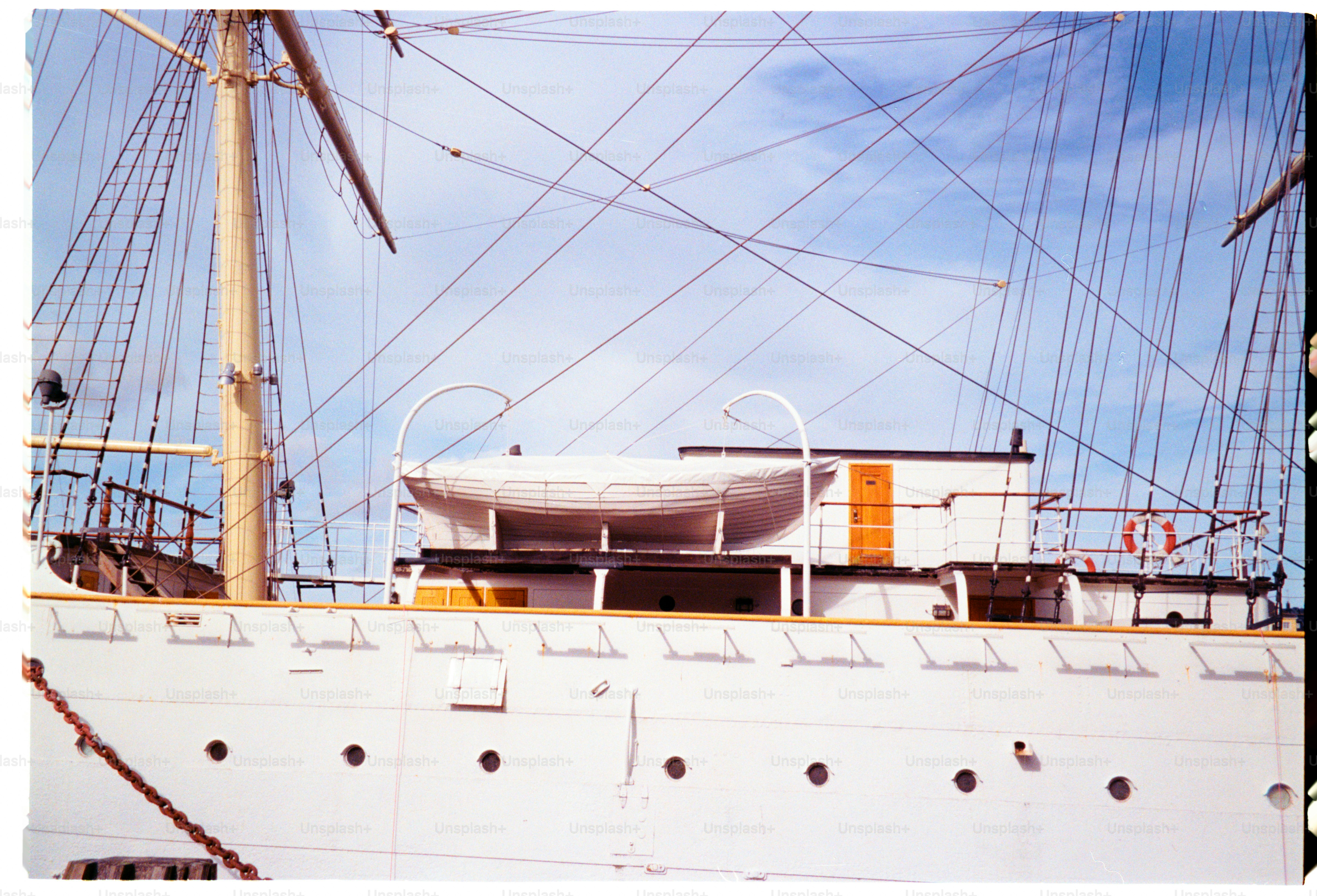 A white ship with tall masts.