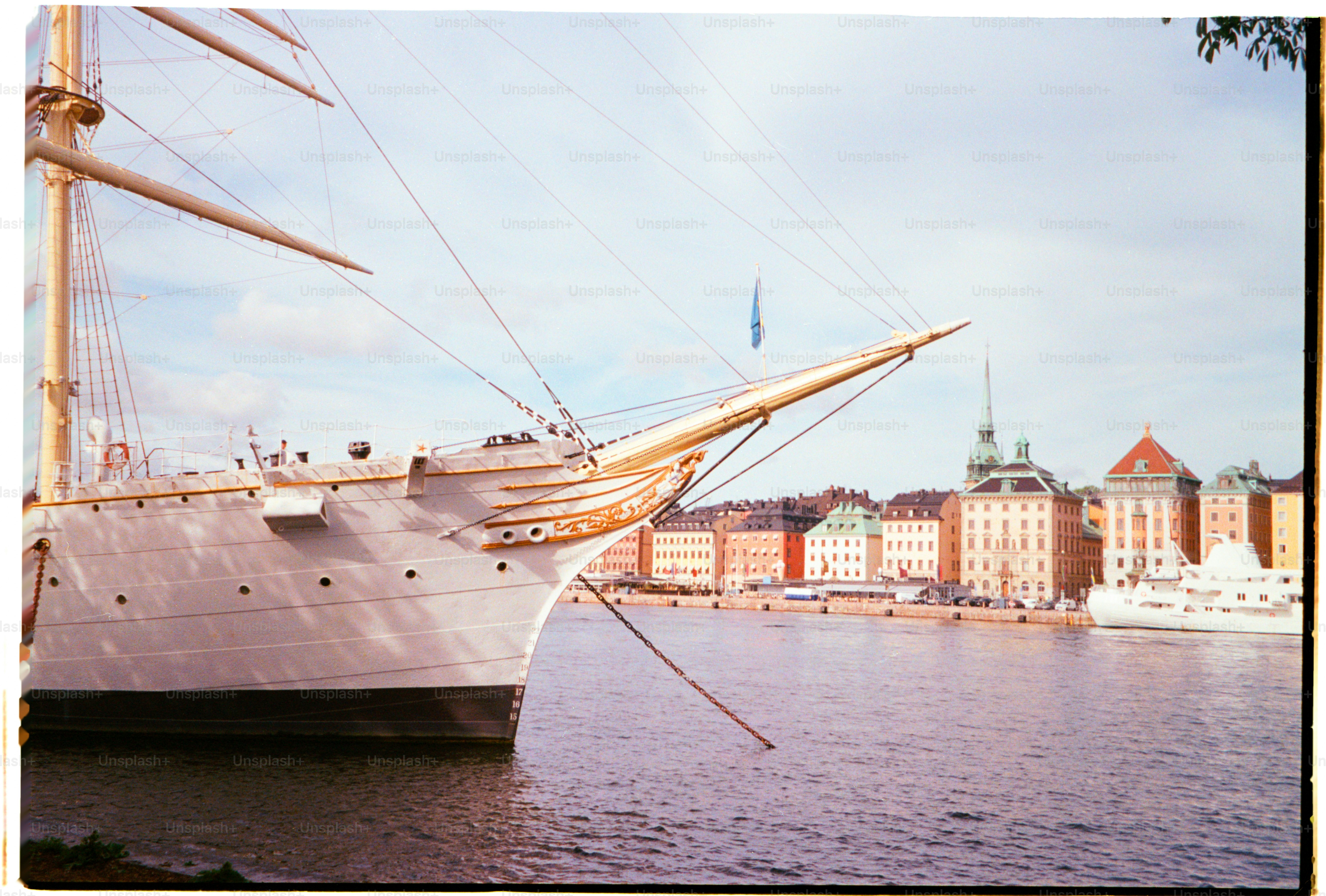 A large ship is docked in a city harbor.